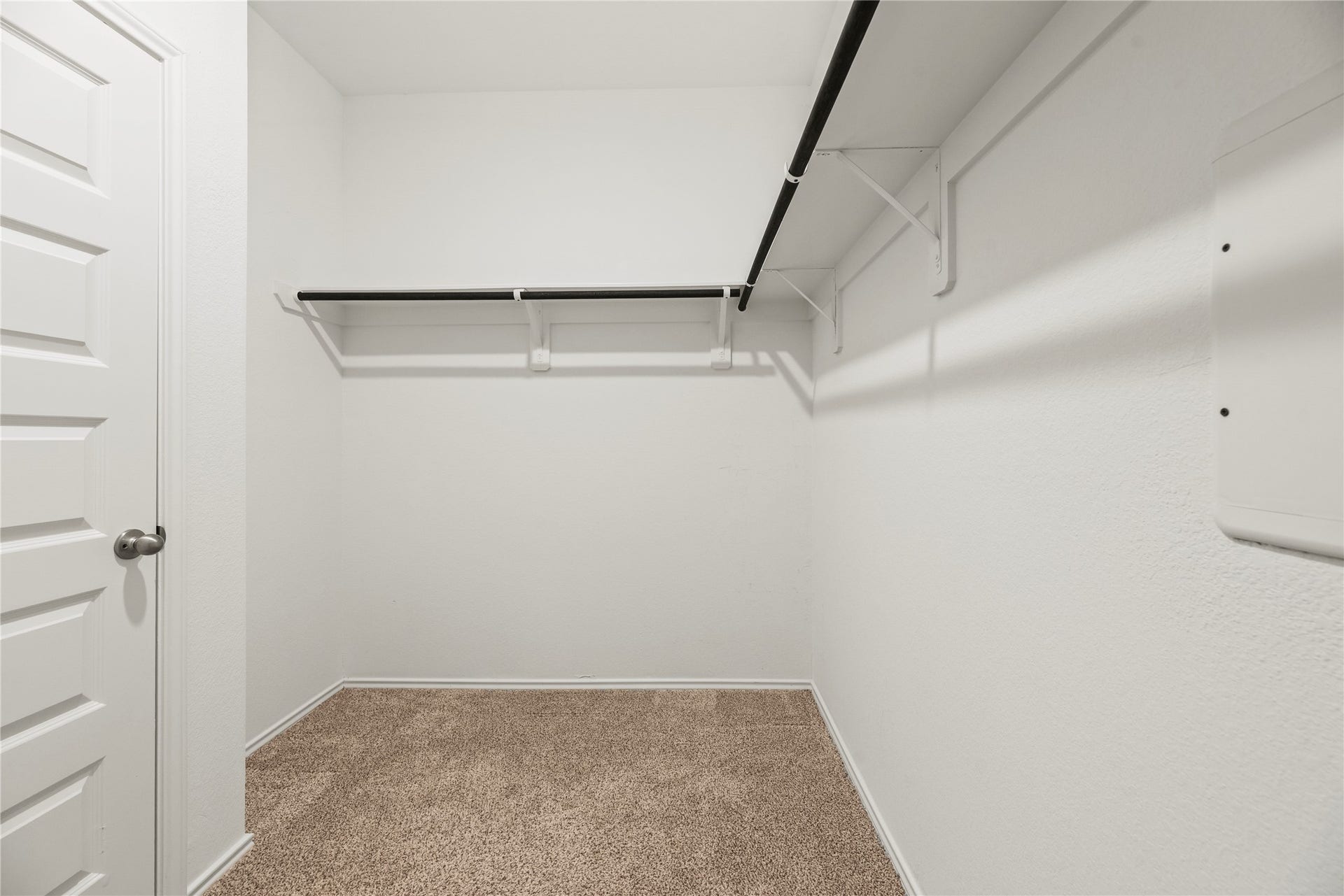 The primary closet offers ample space to store all your clothes and keep everything organized.