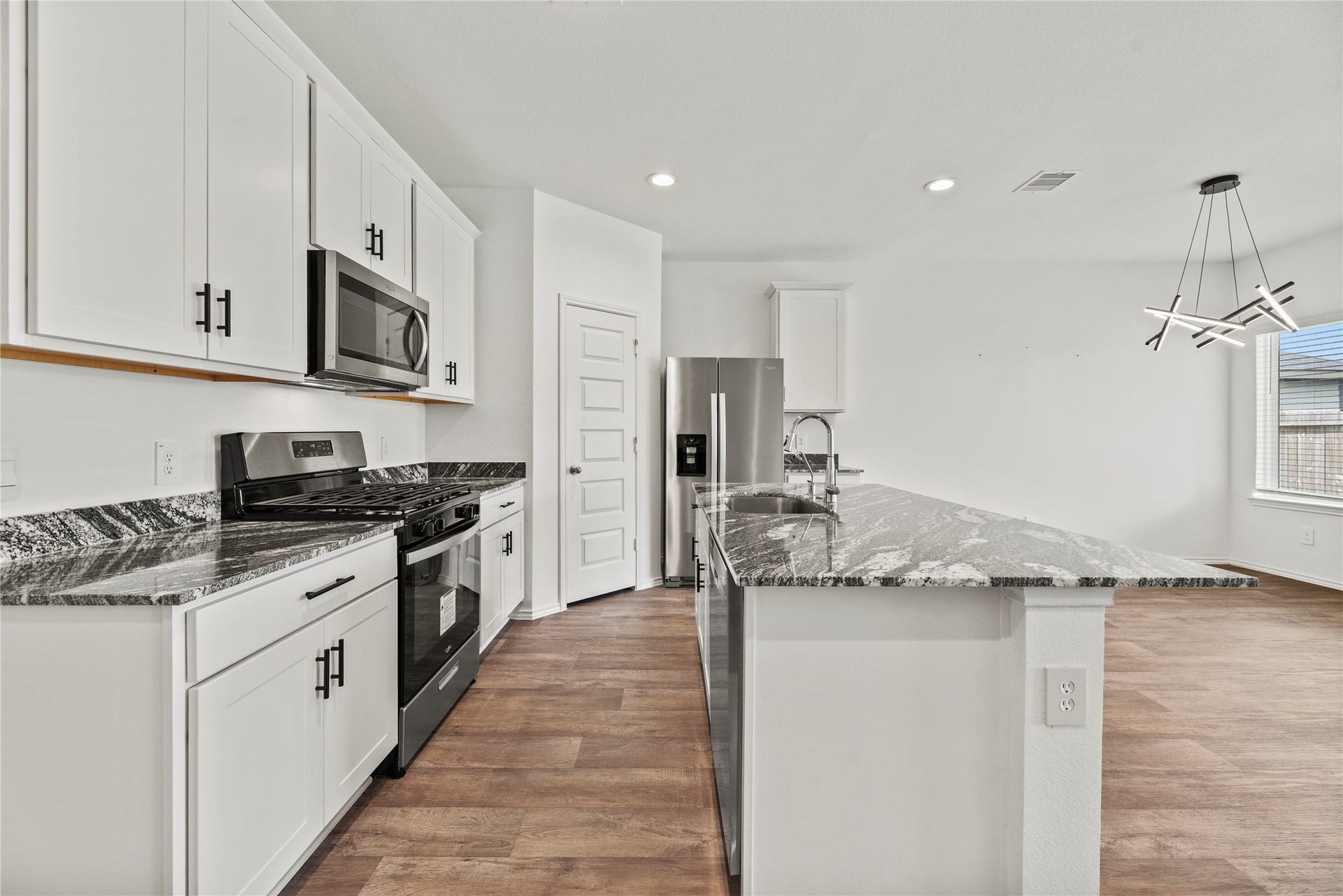 The kitchen features stainless steel appliances, soft-closing cabinets and a spacious walk-in pantry.