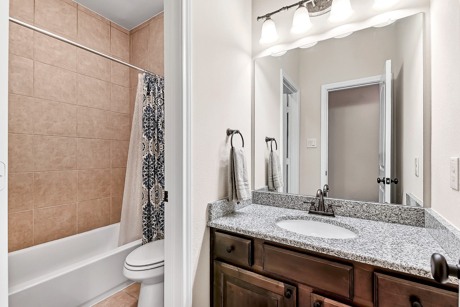 27411 Gladway Manor Drive, Katy, TX 77494 Updated full guest bathroom conveniently located next to one of the upstairs bedrooms, making it ideal for family members and overnight guests. The thoughtfully designed space offers comfort, convenience, and easy access from the surrounding living areas.