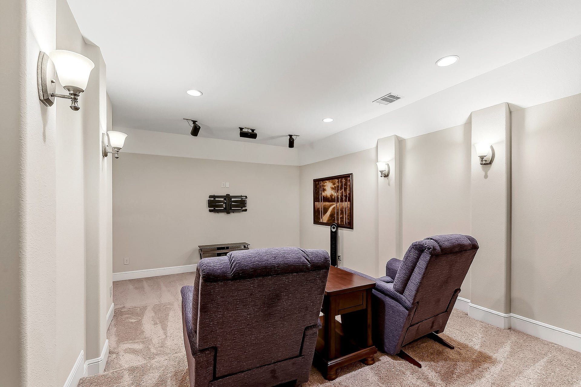27411 Gladway Manor Drive, Katy, TX 77494 French doors open into this luxurious home cinema, featuring high ceilings, tiered seating, dimmable sconce lighting, and recessed lights. Wired for surround sound, this impressive space creates the perfect atmosphere for an immersive movie-night experience.