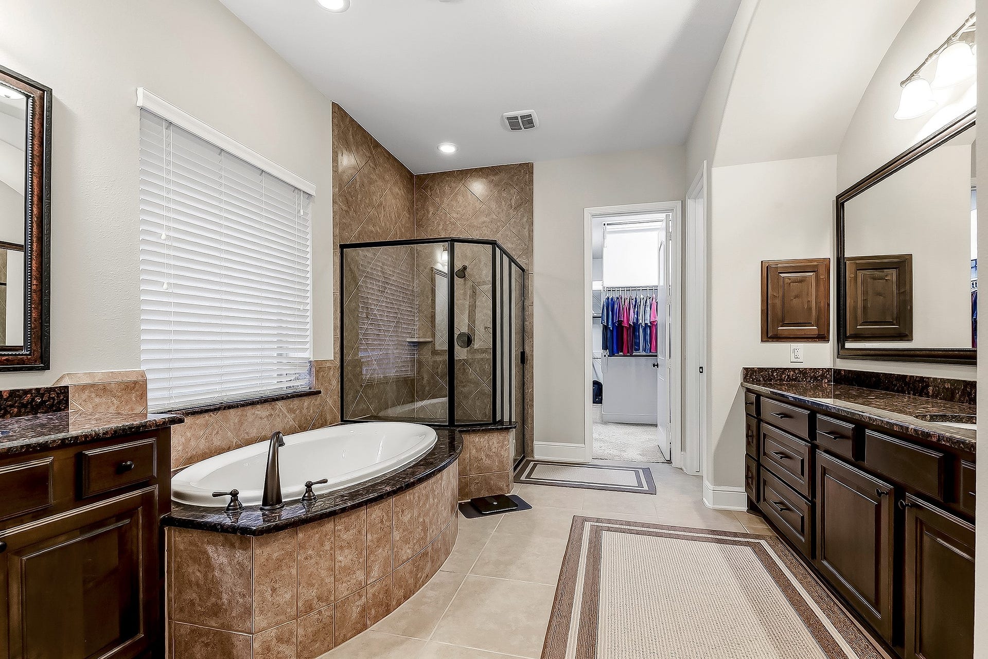 27411 Gladway Manor Drive, Katy, TX 77494 Welcome to this spacious, spa-like primary bathroom featuring dual vanity sinks, a large soaking garden tub, a walk-in shower, and an oversized walk-in wardrobe closet. This thoughtfully designed space offers plenty of storage, functionality, and a serene atmosphere for relaxing and unwinding.