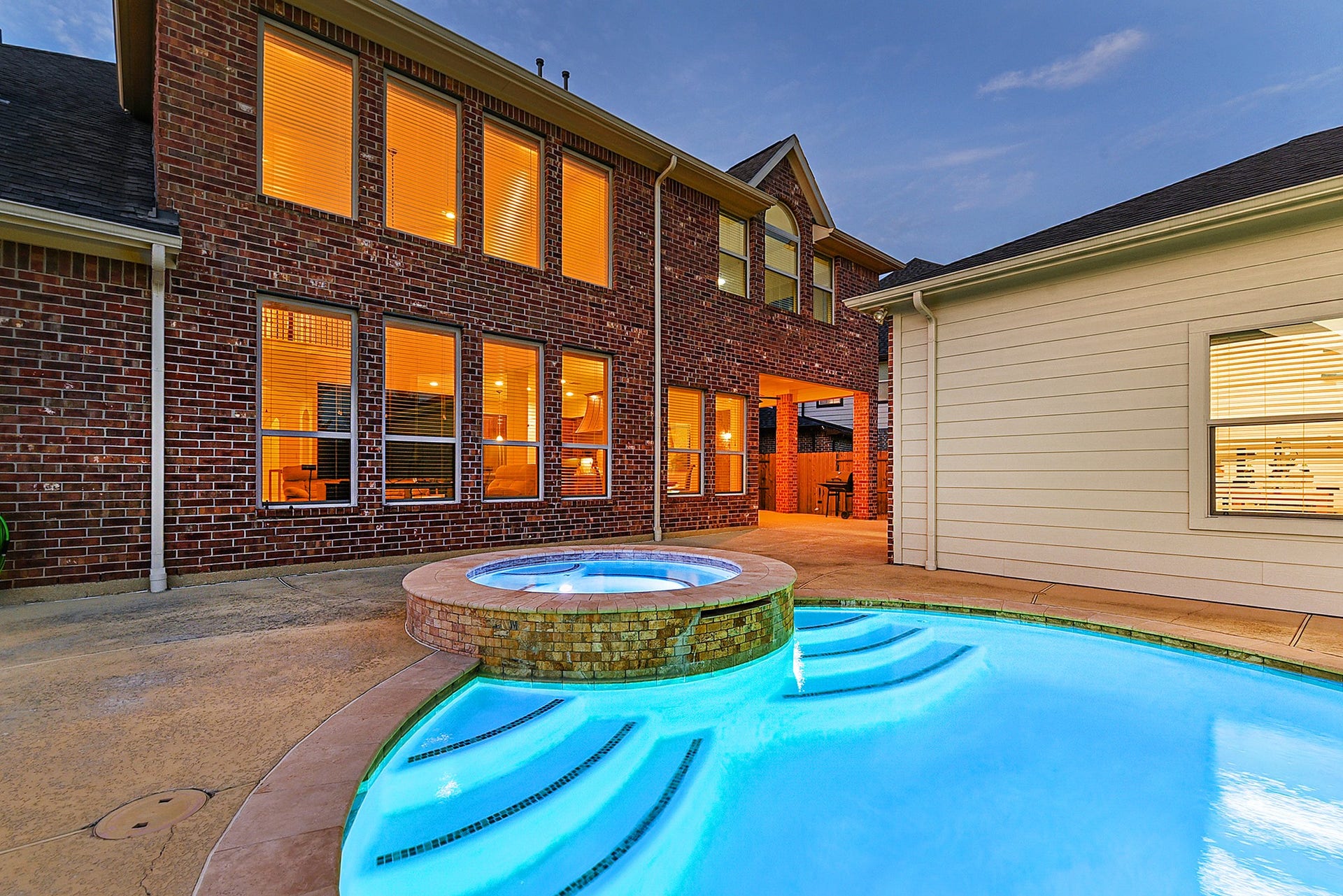 27411 Gladway Manor Drive, Katy, TX 77494 The sparkling blue pool features a heated spa, creating the perfect backyard retreat for relaxing or entertaining. Just steps from the pool is a detached workshop with endless possibilitiesit could be transformed into a pool house, casita, man cave, she-shed, hobby room, or creative space. From the living rooms rear windows, enjoy beautiful views overlooking the pool and backyard.