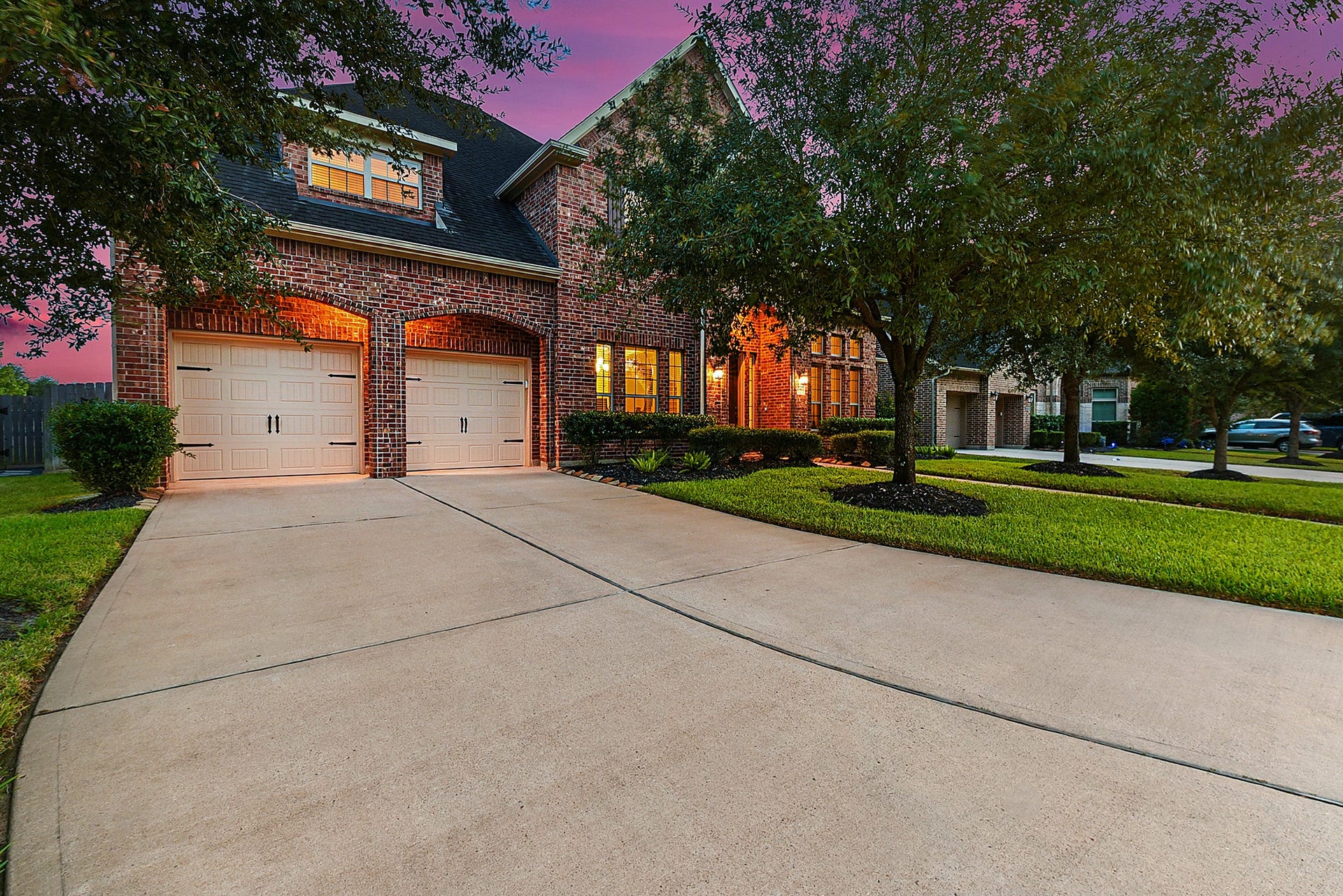 27411 Gladway Manor Drive, Katy, TX 77494 A huge driveway leads to the spacious three-car attached garage, providing plenty of room for multiple vehicles and guest parking. The generous driveway also offers additional space for outdoor play and activities.