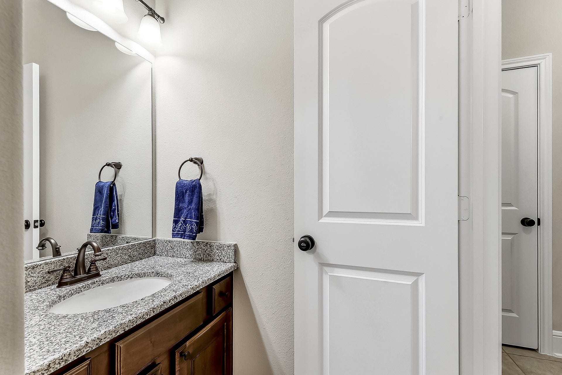 27411 Gladway Manor Drive, Katy, TX 77494 The shared Hollywood-style bathroom conveniently connecting two of the upstairs guest bedrooms. The bathroom features a full-size vanity with generous counter space and plenty of storage, providing a practical and comfortable setup for family members or overnight guests. Its direct access from both bedrooms adds convenience while maintaining a functional layout.