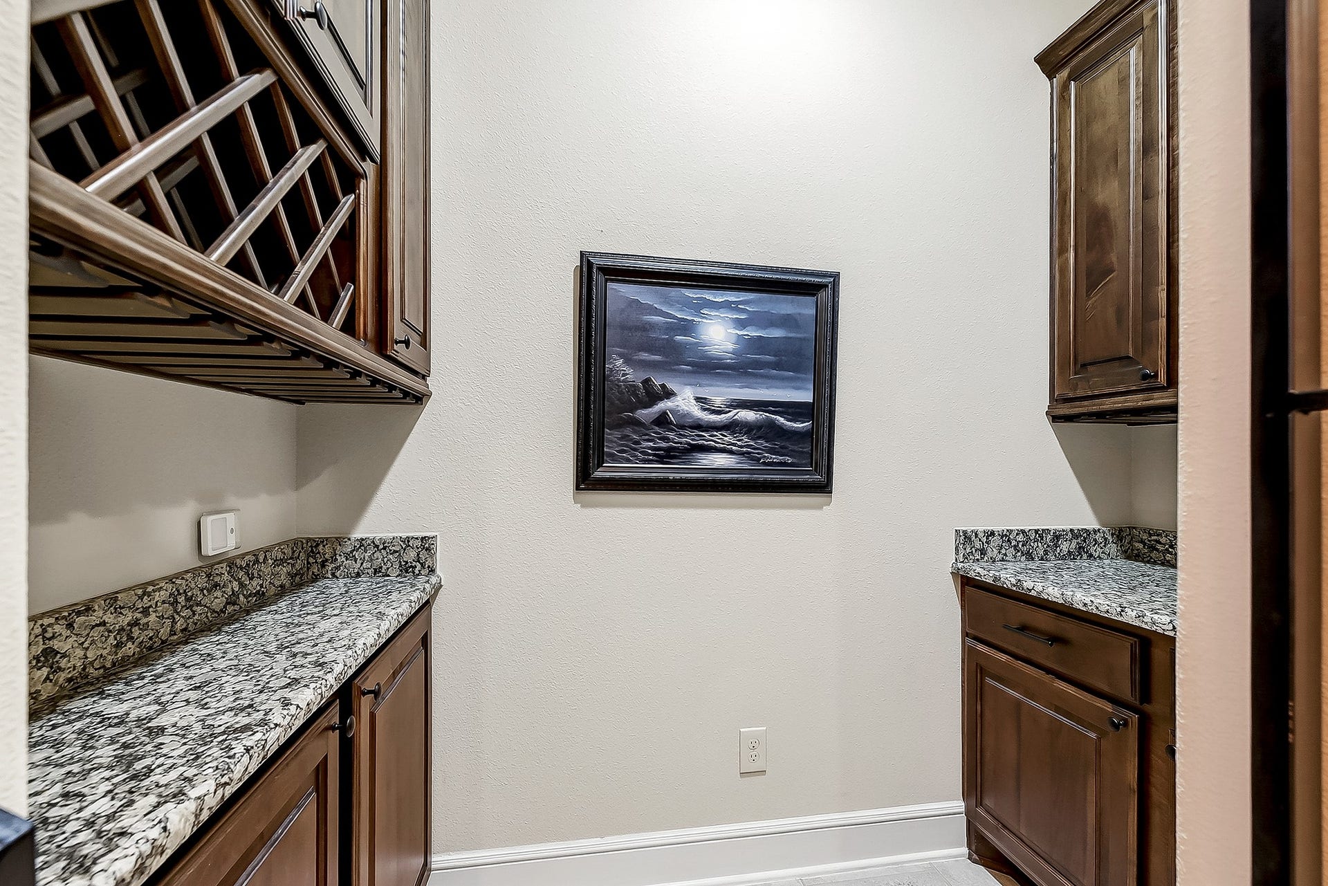 27411 Gladway Manor Drive, Katy, TX 77494 Take a closer look at this charming wine grotto, featuring a beautiful wrought-iron gate, additional cabinetry, and generous counter space. Perfect for storing your favorite bottles and accessories, this versatile space can also be used as a convenient coffee station.