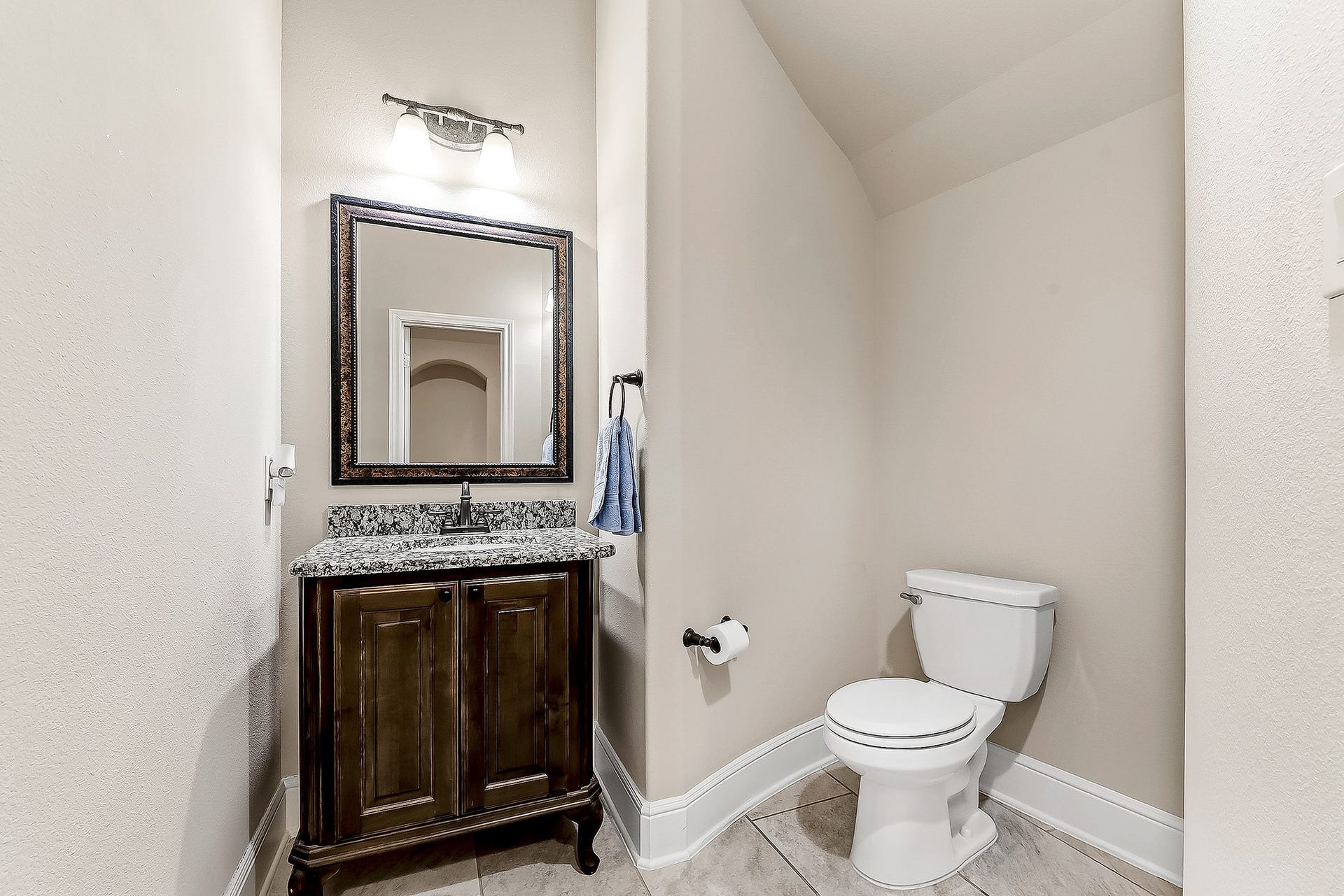 27411 Gladway Manor Drive, Katy, TX 77494 The main-floor powder room features a full vanity with sink, offering a convenient and thoughtfully designed space for guests.