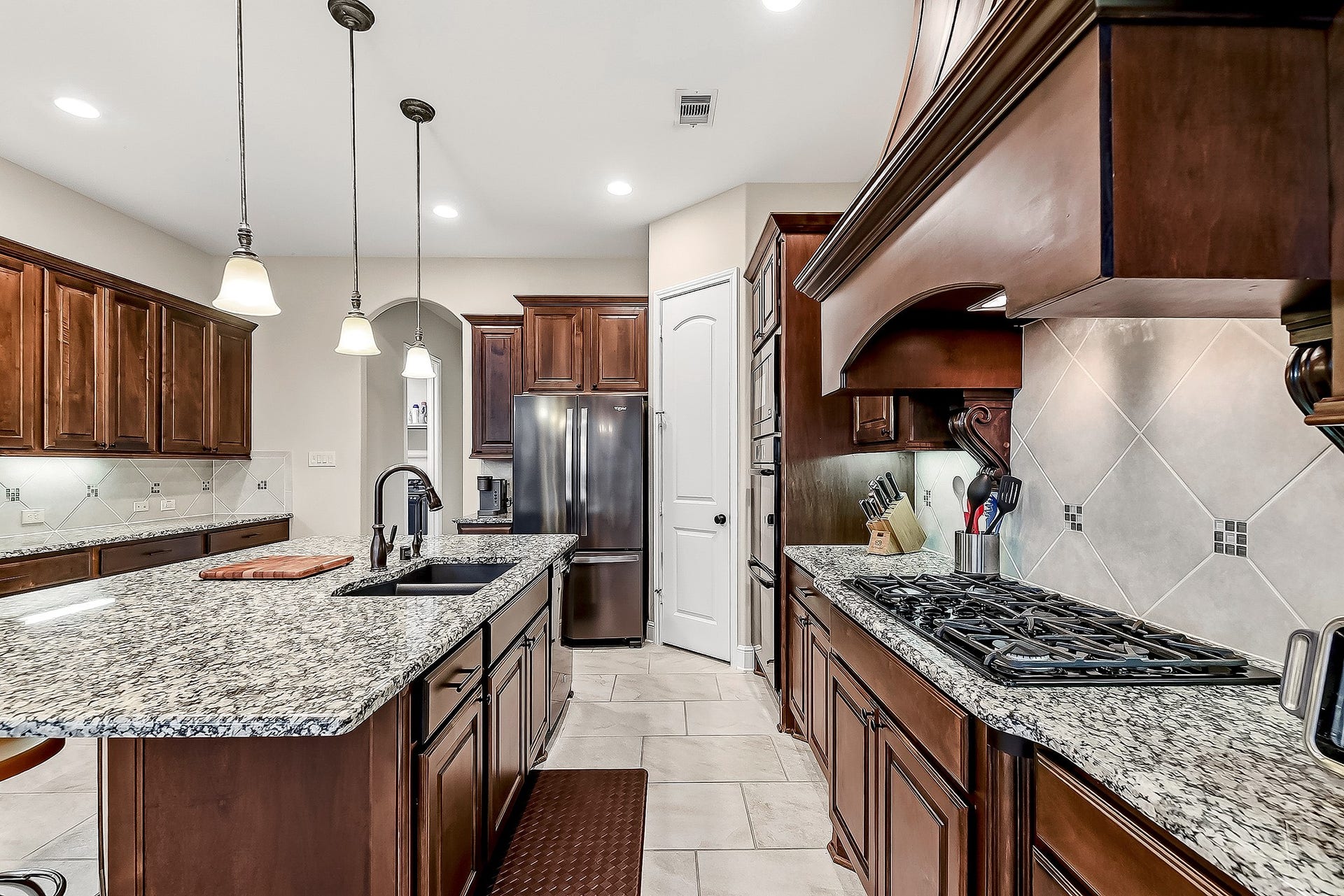 27411 Gladway Manor Drive, Katy, TX 77494 As you step into this impressive island kitchen, youll notice the abundance of cabinetry and expansive granite countertops, offering plenty of workspace and storage. The kitchen features a spacious walk-in pantry, built-in wall microwave, and double oven for added convenience. Recessed lighting, under-cabinet lighting, and pendant lights over the island provide a warm, inviting atmosphere