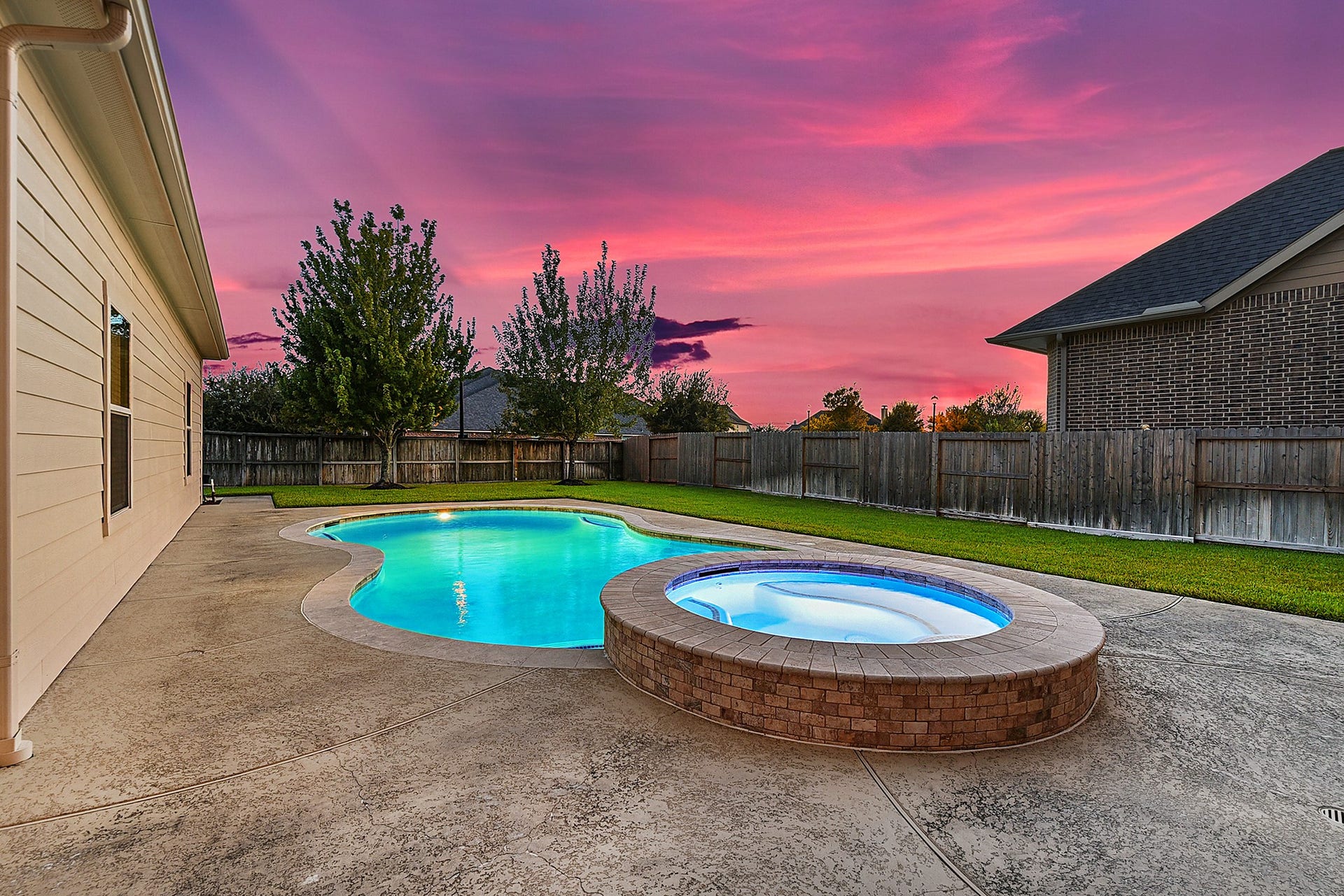 27411 Gladway Manor Drive, Katy, TX 77494 This inviting outdoor space is perfect for entertaining, featuring ample green space for both recreation and relaxation. The pool is accented by elegant stone coping, a cool-deck surround, and pool lighting that creates a beautiful ambiance for evening gatherings and outdoor enjoyment.