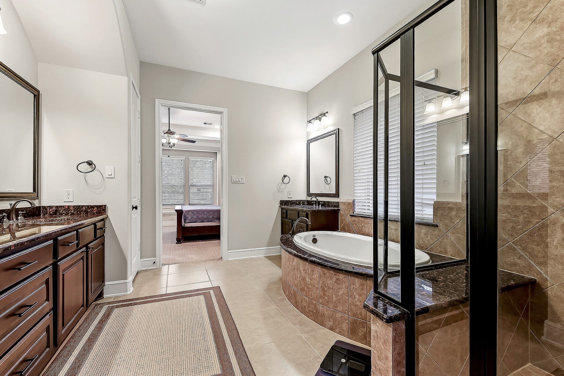 27411 Gladway Manor Drive, Katy, TX 77494 Another view of this spa-like bathroom showcases its generous space, beautiful granite surround around the garden tub, and large walk-in tiled shower complete with a built-in bench seat. Thoughtful details create a comfortable and relaxing retreat.