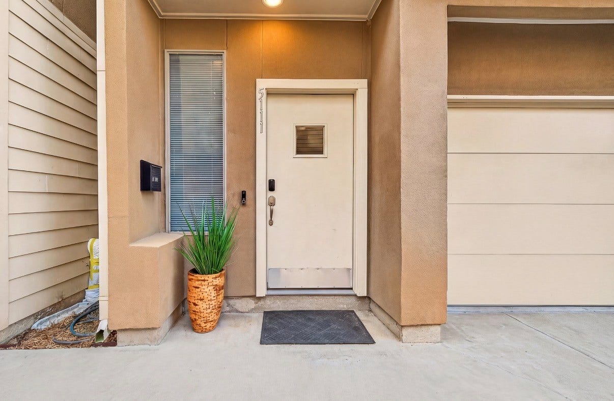 5111 Cornish Street, Houston, TX 77007 Charming entrance with a modern door and a welcoming potted plant, complemented by clean lines and contemporary design.