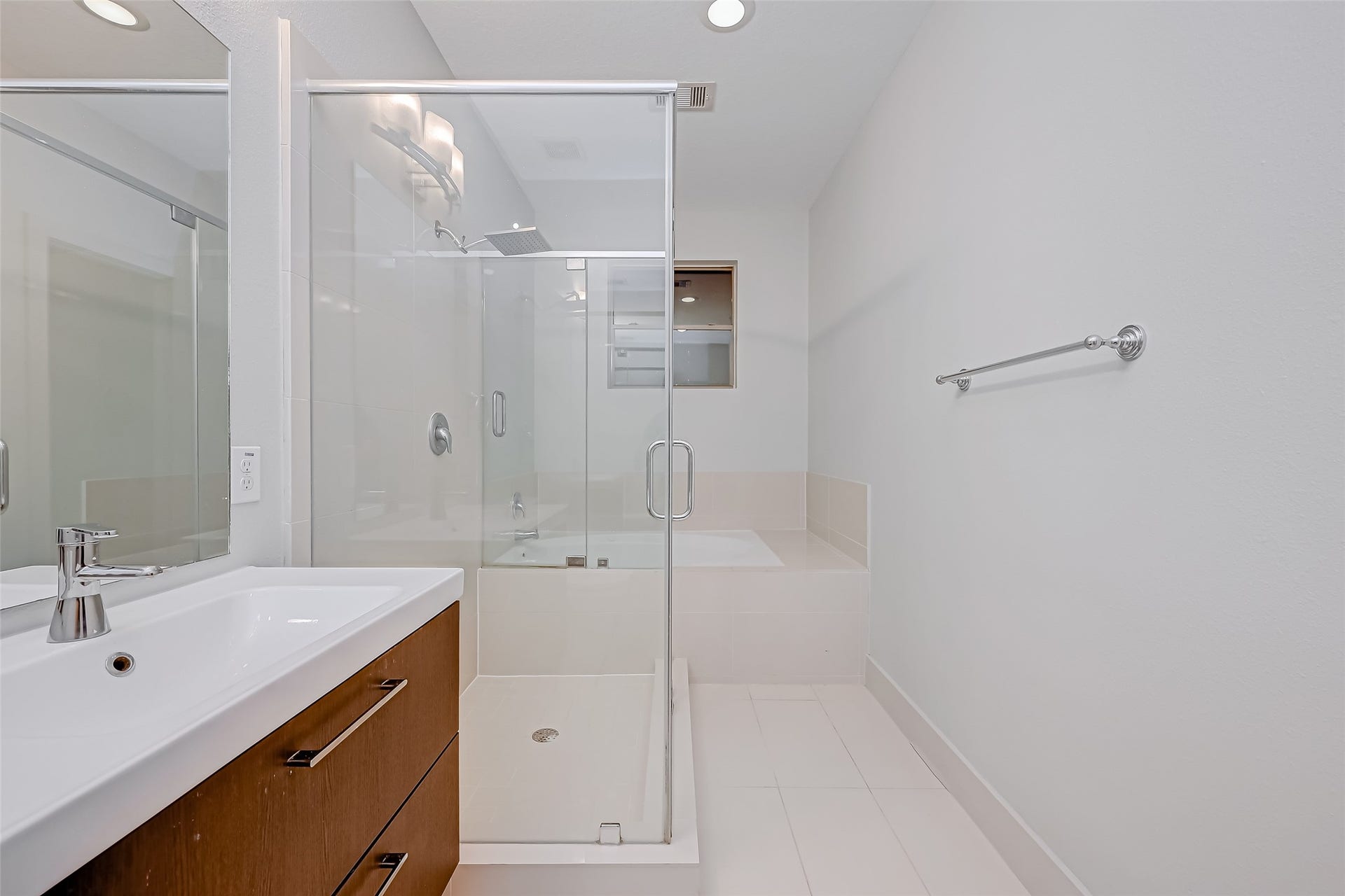 5111 Cornish Street, Houston, TX 77007 Sleek and modern bathroom featuring a spacious glass-enclosed shower, elegant vanity with ample storage, and a soothing color palette for a relaxing atmosphere.
