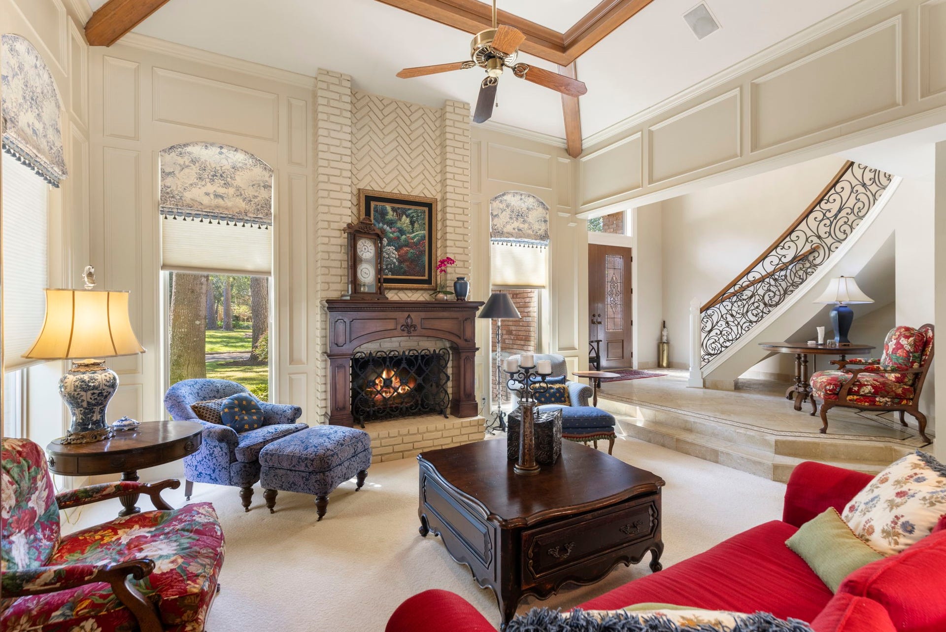 14018 Court Of Regents, Houston, TX 77069 Soaring ceilings, substantial millwork, and a striking fireplace create a grand yet comfortable setting for gathering.