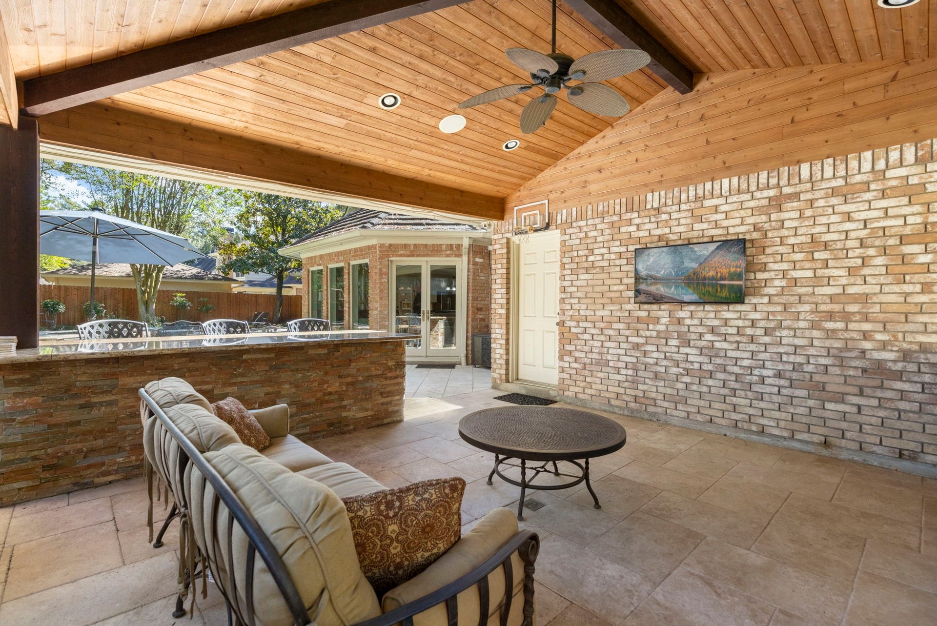 14018 Court Of Regents, Houston, TX 77069 Ceiling fans and a substantial covered patio offer a comfortable place to linger between swims and outdoor meals.