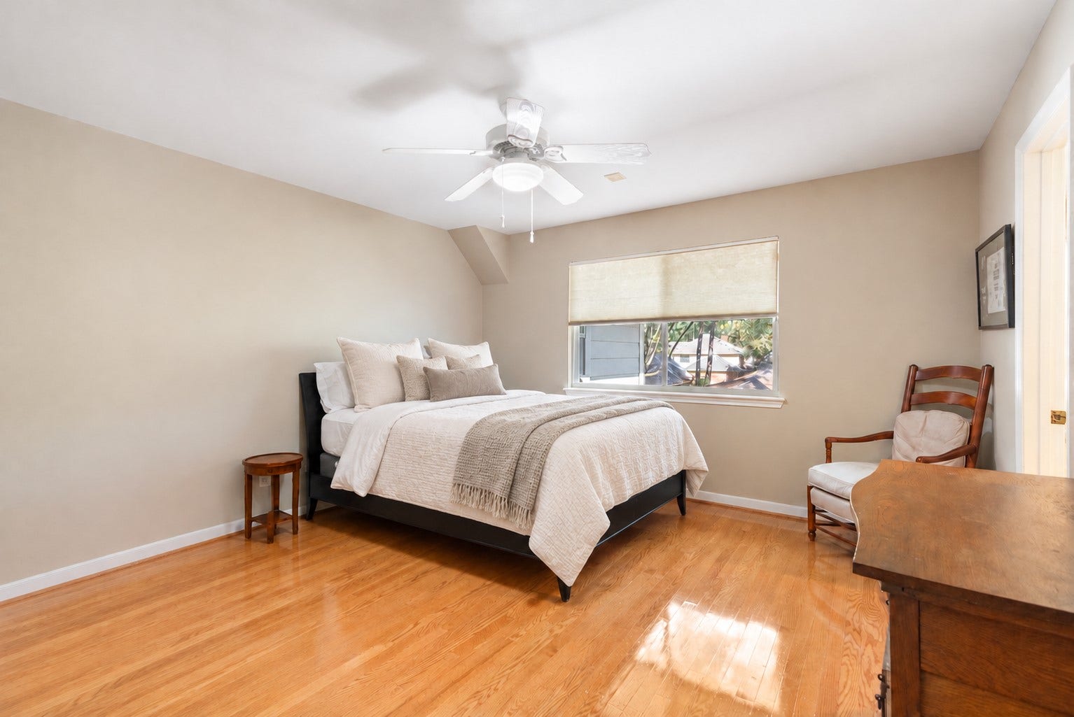 14018 Court Of Regents, Houston, TX 77069 Wood flooring and a wide window give this secondary oversized bedroom a bright, welcoming feel with flexibility for guests or everyday living.