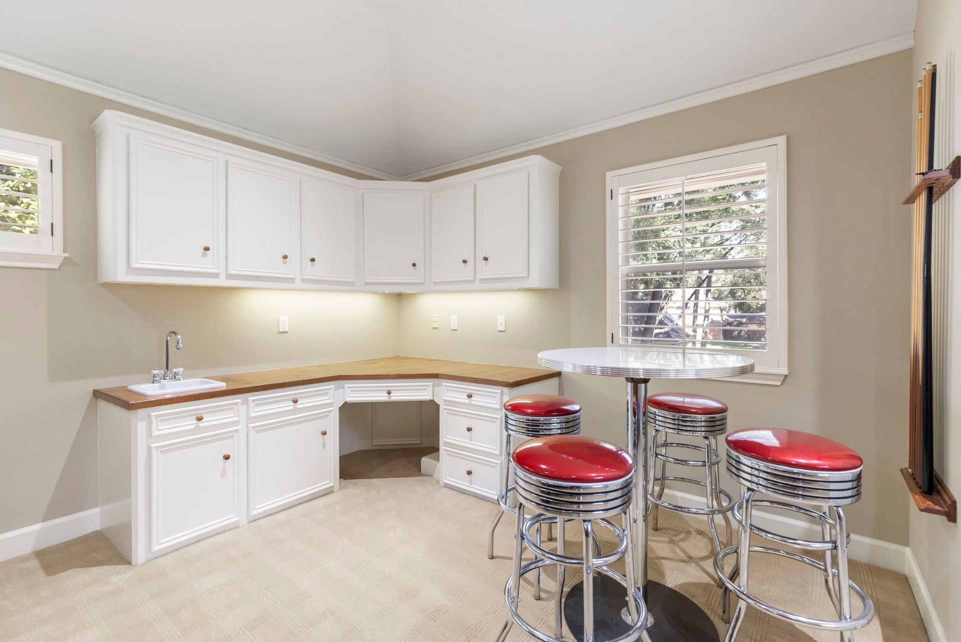 14018 Court Of Regents, Houston, TX 77069 A convenient kitchenette with a sink, cabinetry, and counter seating keeps snacks and refreshments close to the game room.