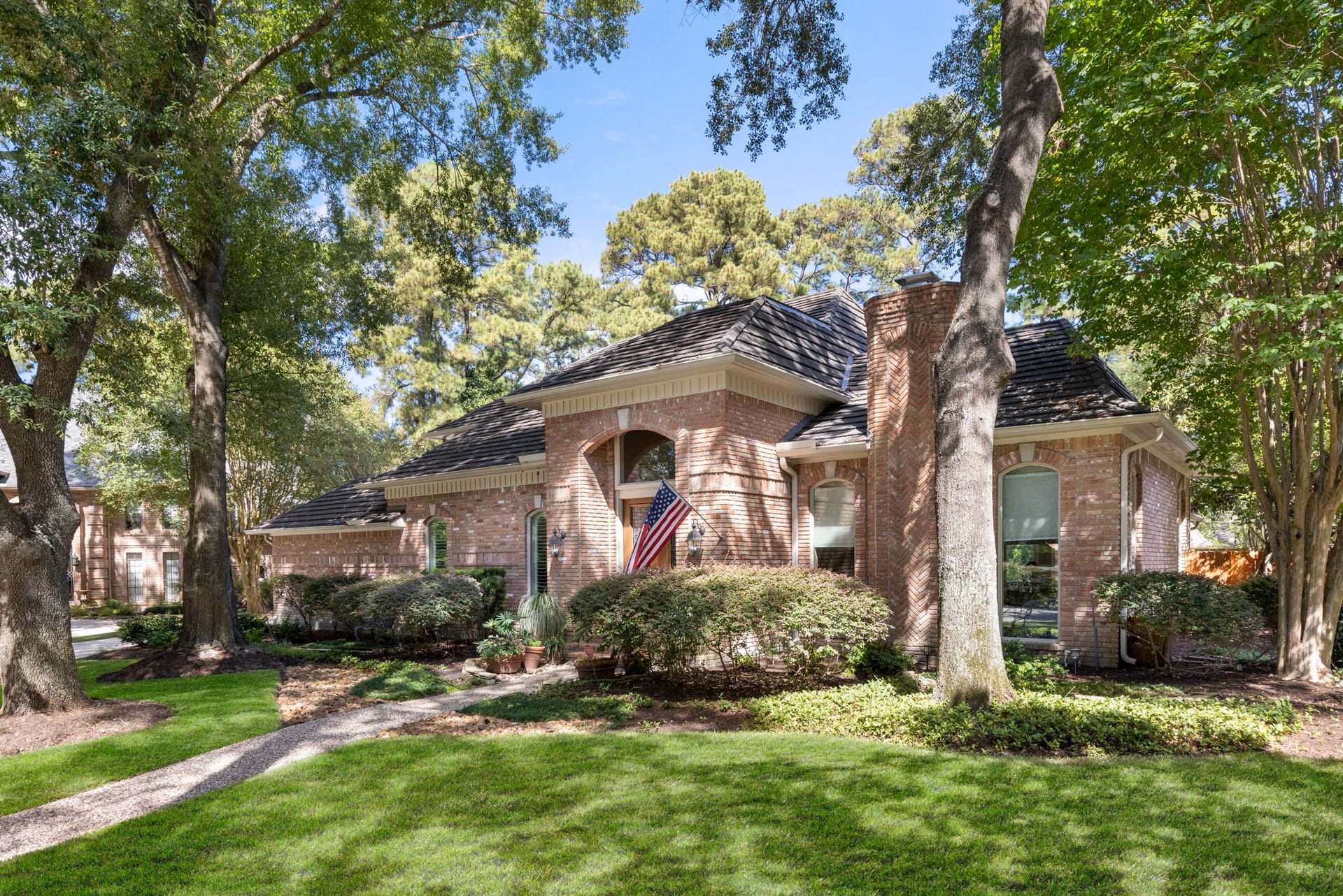 14018 Court Of Regents, Houston, TX 77069 Classic brickwork and mature landscaping are complemented by a Hurricane metal shake roof installed in 2021 with a transferable warranty.