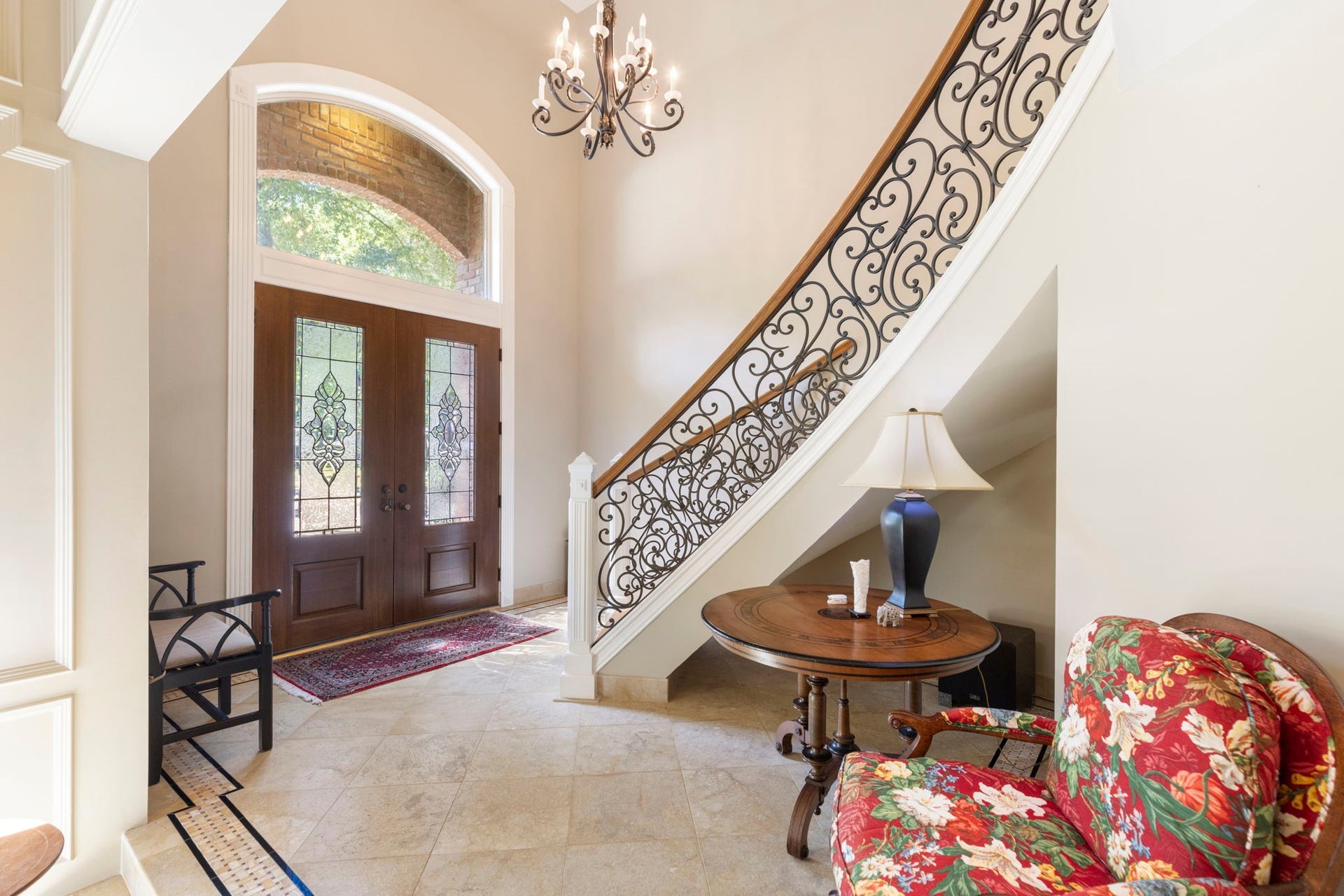 14018 Court Of Regents, Houston, TX 77069 Curved stair detailing and richly framed entry doors bring architectural character to a welcoming foyer with inviting views into the living spaces.