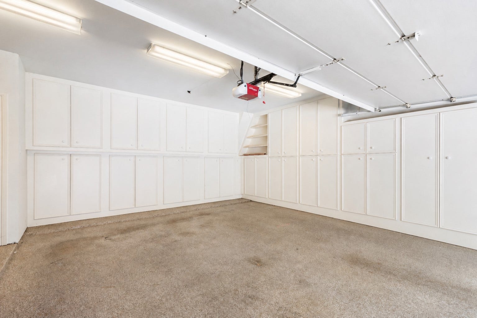 14018 Court Of Regents, Houston, TX 77069 Extensive enclosed garage cabinetry keeps tools, supplies, and seasonal belongings neatly tucked away. The other side of garage has even more storage and built-ins.