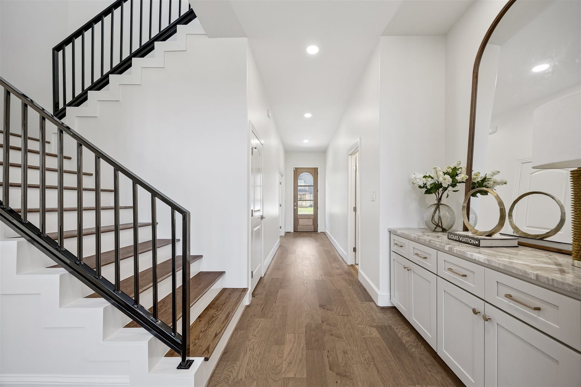 Premium finishes and extensive upgrades shine throughout, including wood floors, luxury appliances with an oversized range, and abundant custom storage.