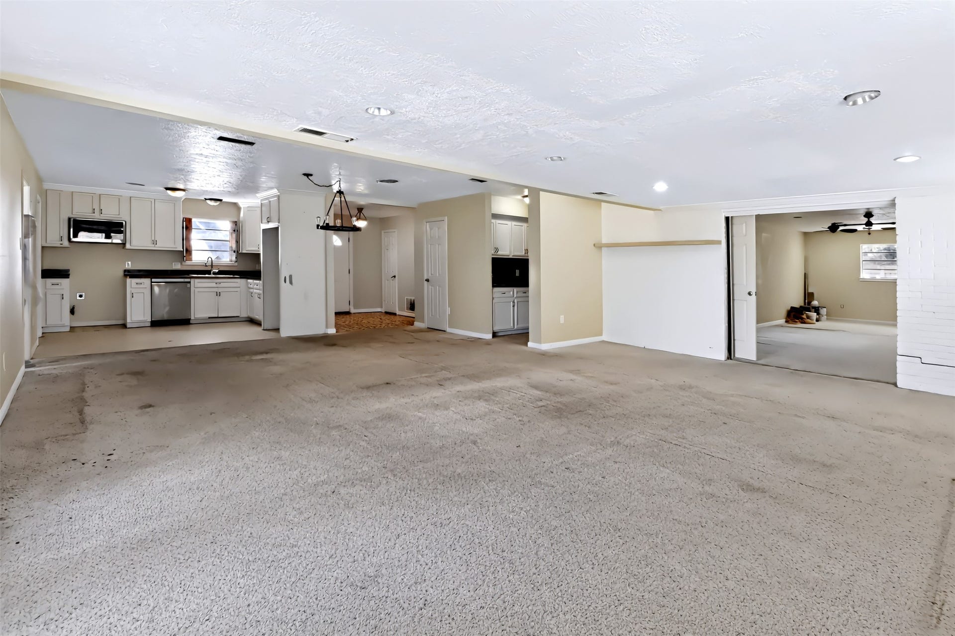 211 Rue Orleans Street, Baytown, TX 77520 Kitchen, dining, living room and extra bedroom to the right
