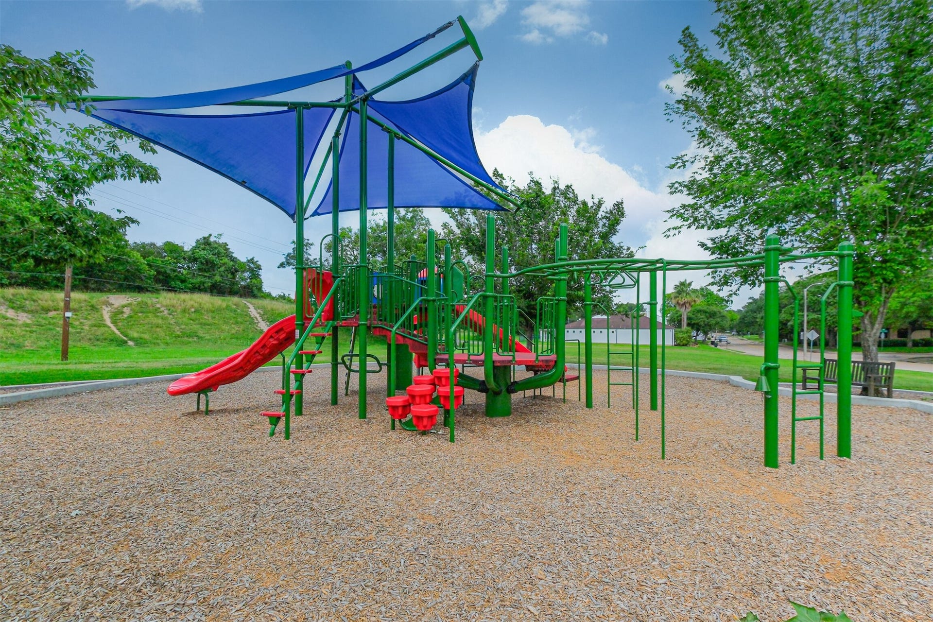 14211 Swiss Hill Drive, Houston, TX 77077 The playground is next to a big field where you can picnic, kick a soccer ball around, play tag, etc.