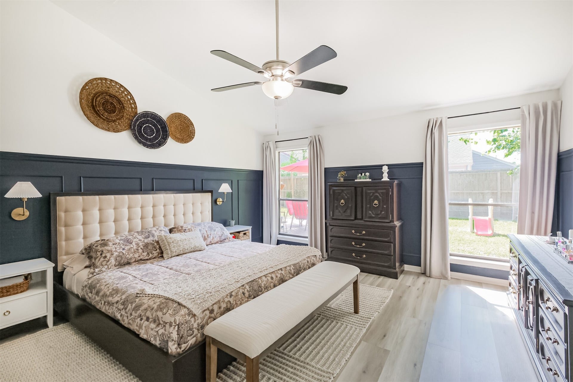 14211 Swiss Hill Drive, Houston, TX 77077 All bedrooms are located on the first floor! The primary is very spacious with high ceilings, a ceiling fan, wainscotting and views of the backyard.