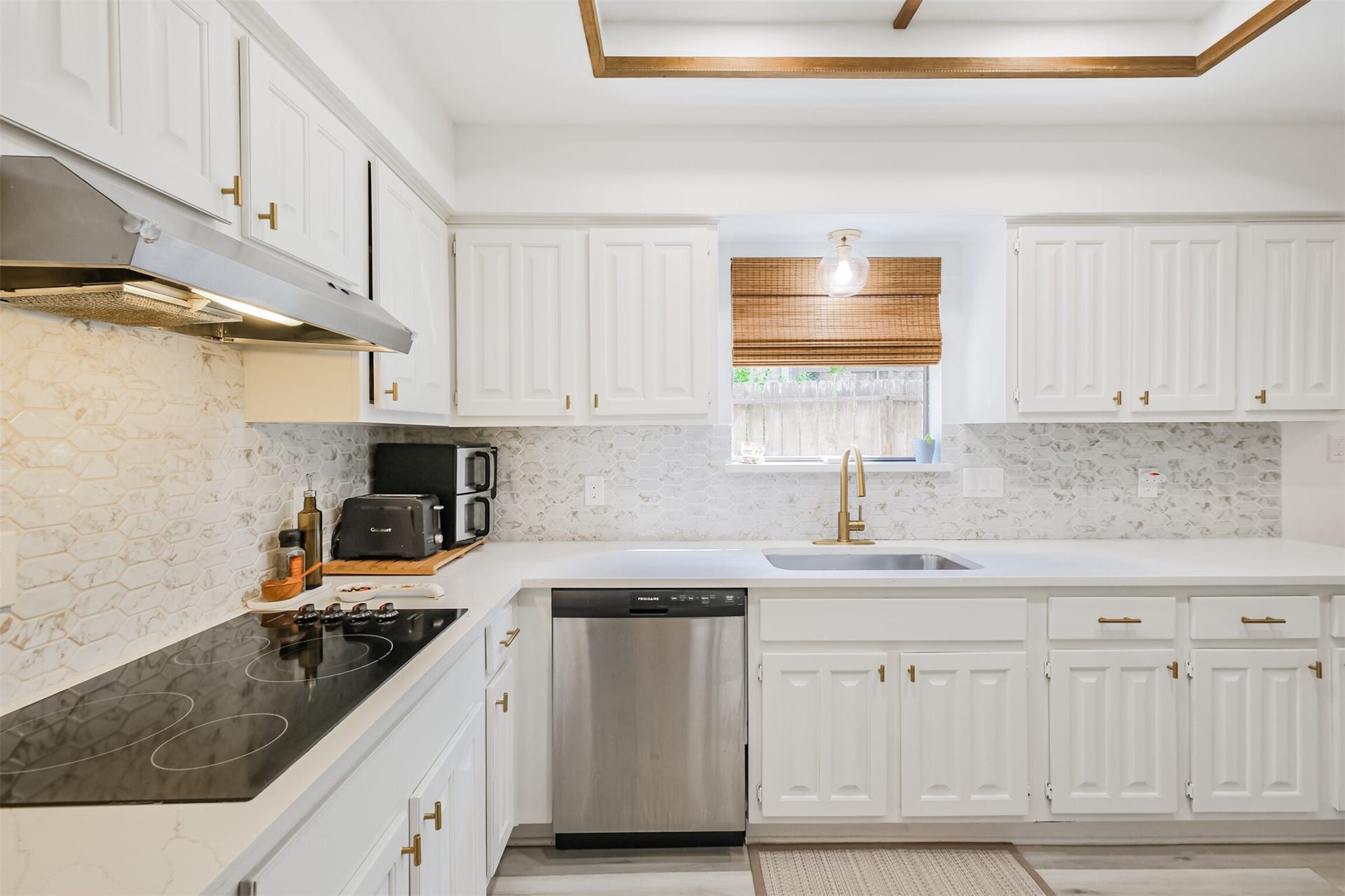 14211 Swiss Hill Drive, Houston, TX 77077 There is a electric cooktop with vent hood and SS dishwasher.