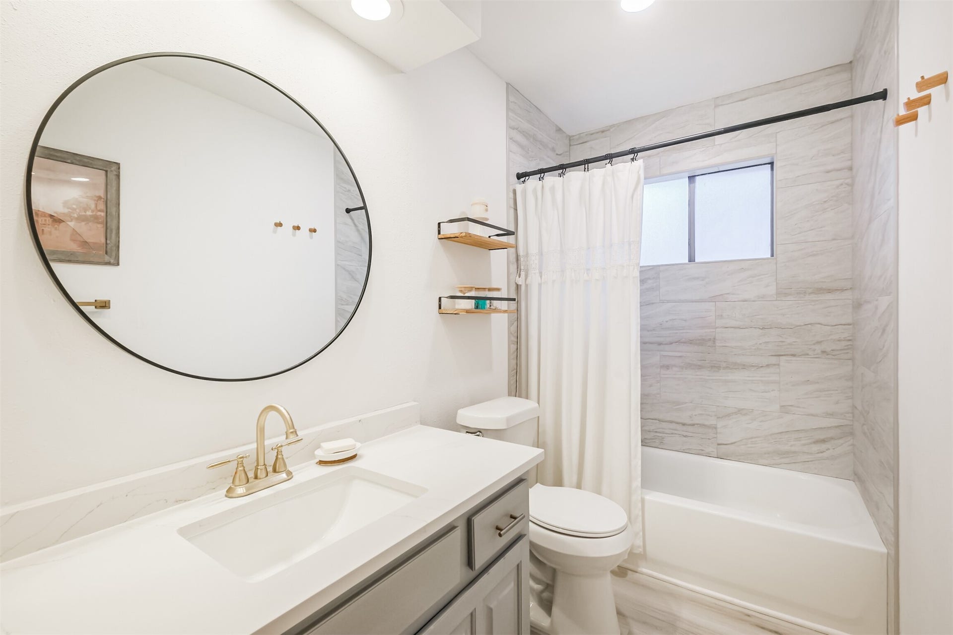 14211 Swiss Hill Drive, Houston, TX 77077 The second full bathroom has been updated with quartz counters, gold faucet and a tub+shower duo with tile surround.