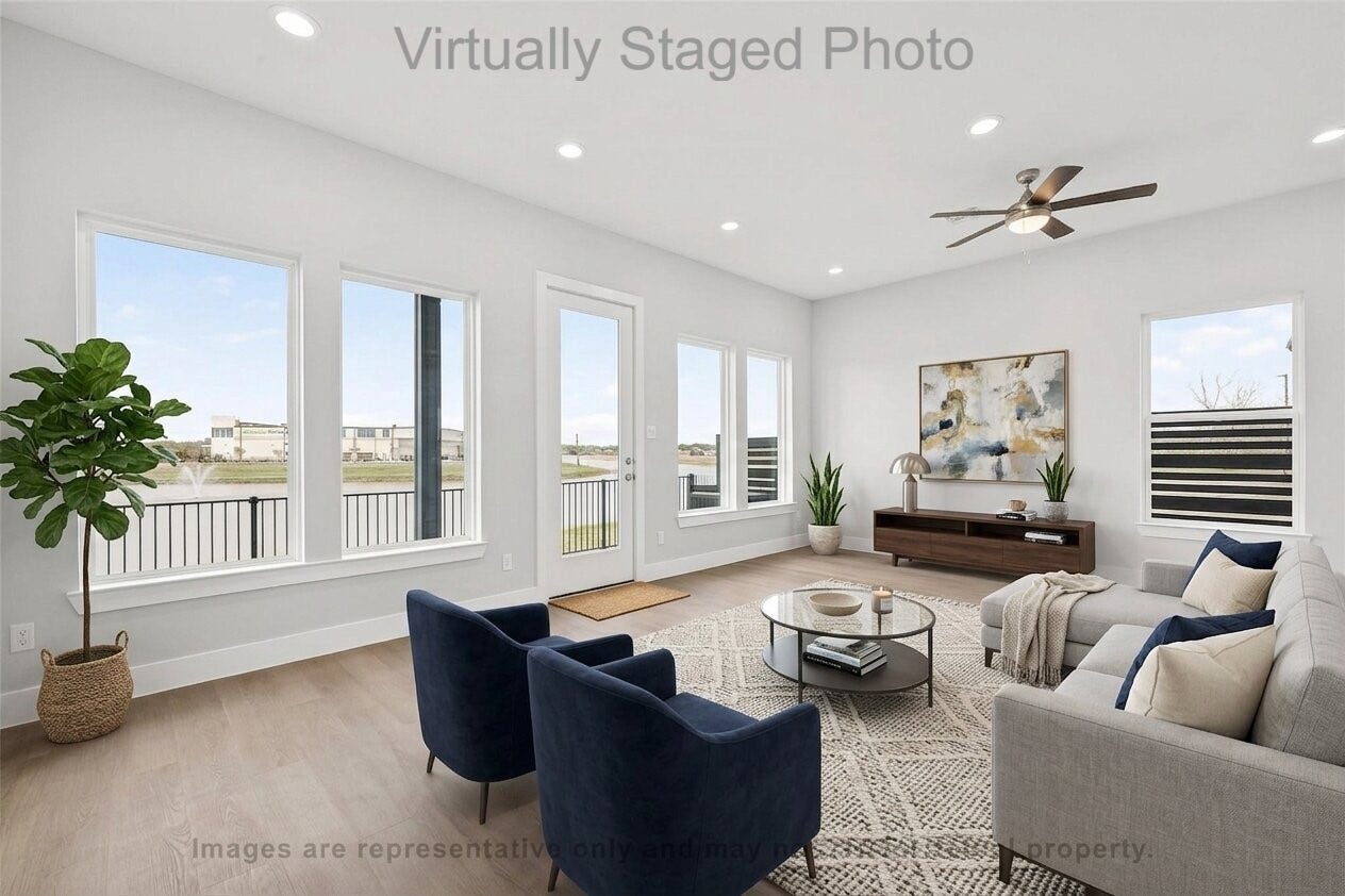 10719 Mason Rd, #32, Richmond, TX 77406 Virtual Staging - Modern living room featuring a gray sectional sofa, two blue armchairs, and large windows with a scenic waterfront view