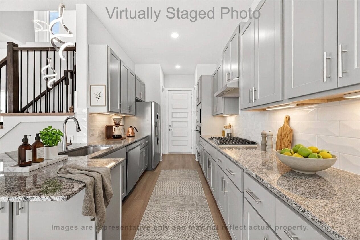 10719 Mason Rd, #32, Richmond, TX 77406 Virtual Staging - Modern galley-style kitchen featuring gray cabinetry, granite countertops, and a long patterned runner rug over light wood flooring