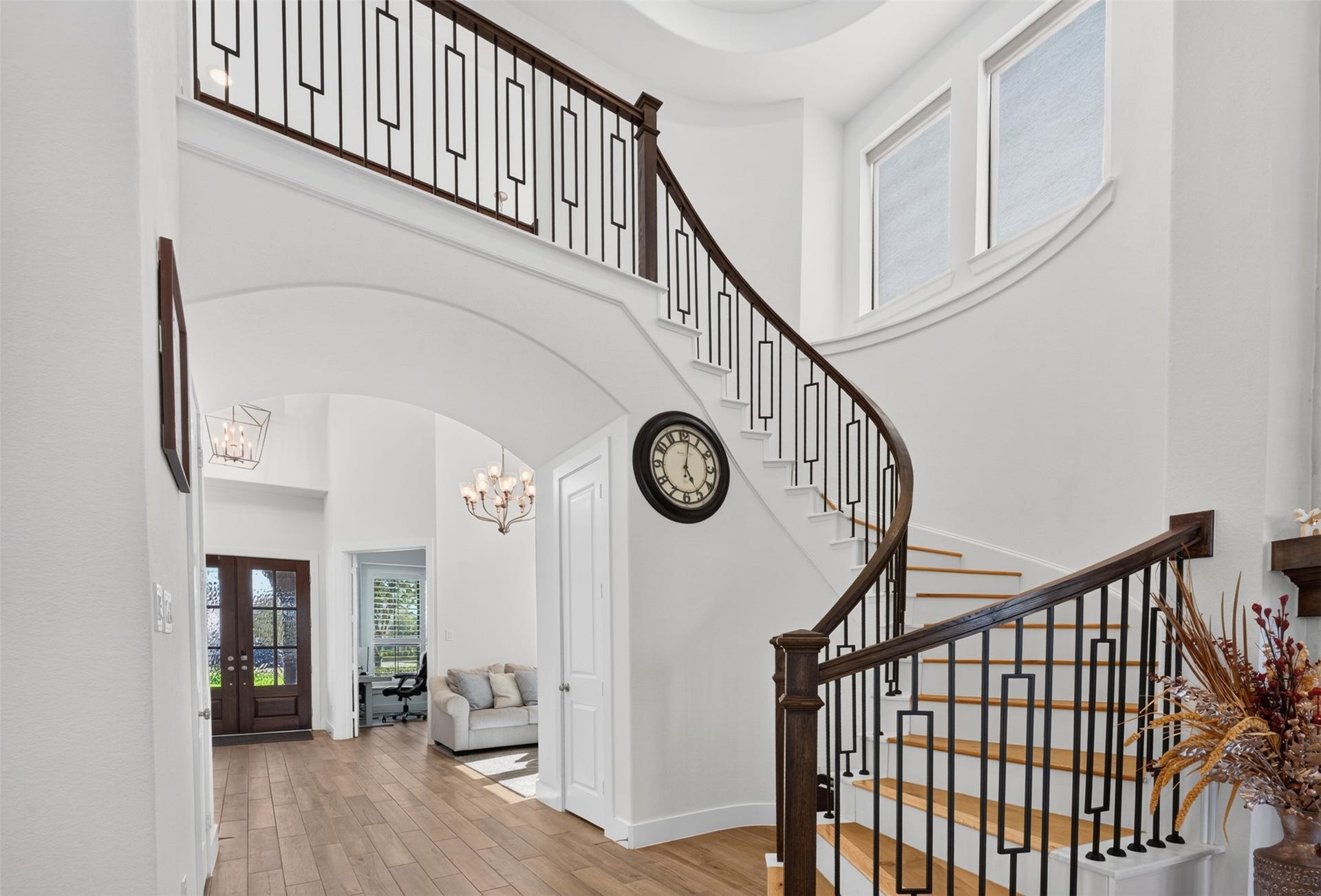 7014 San Bernard Trail, Katy, TX 77493 Open-layout home with elegant spiral stairs and upper-level railing.