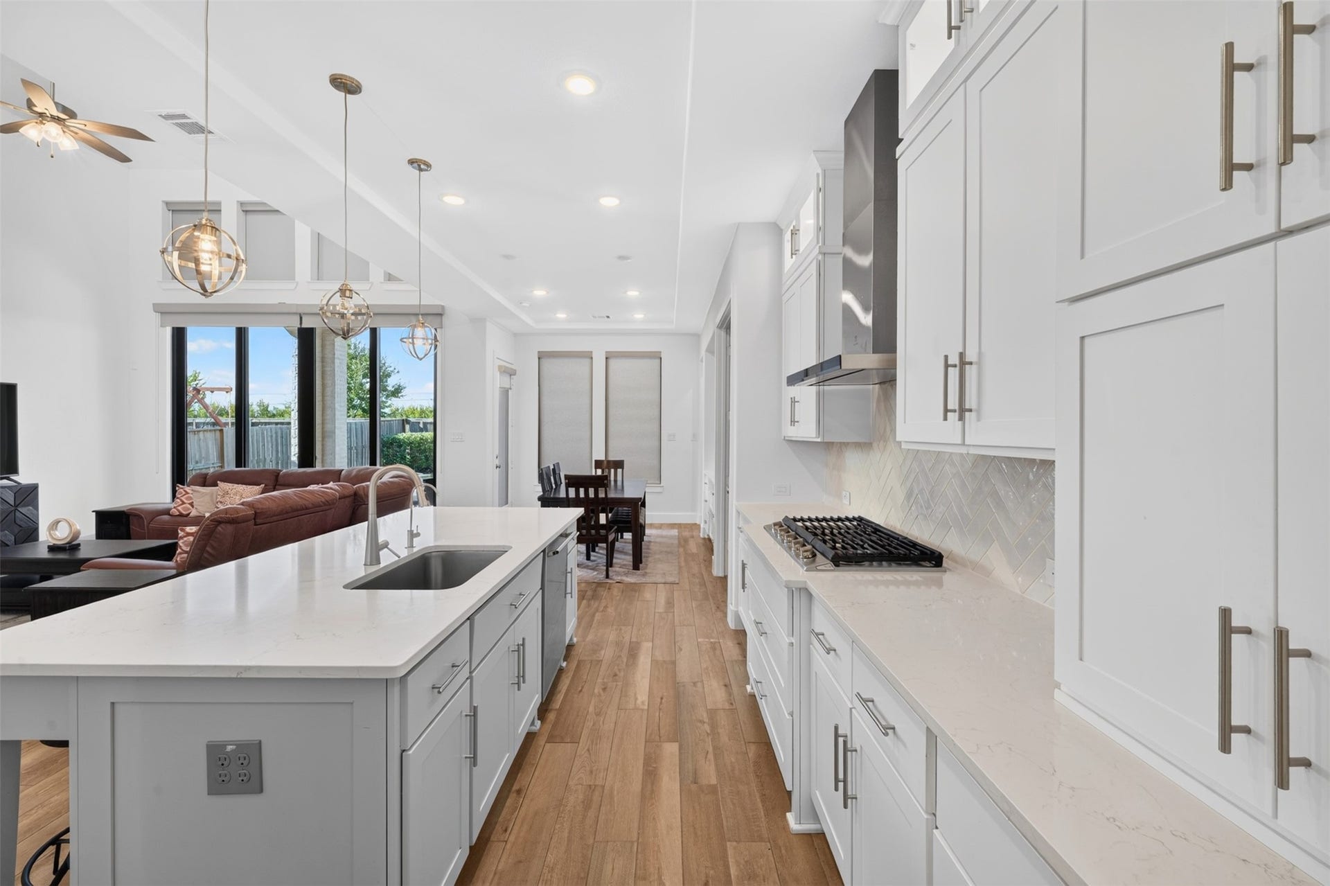 7014 San Bernard Trail, Katy, TX 77493 Bright and inviting living area with high ceilings, a modern chandelier, and large windows.