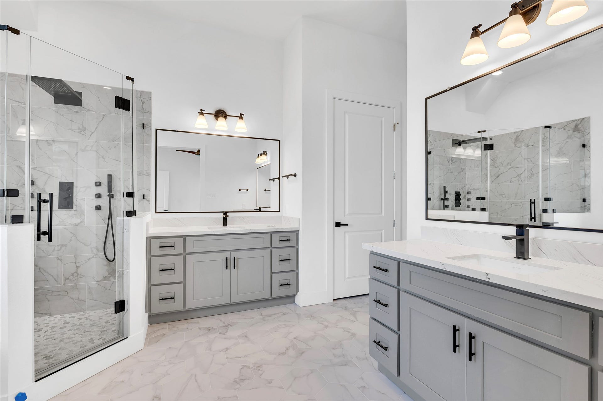 119 Kirby Road, #5303, Taylor Lake Village, TX 77586 Luxurious bathroom featuring a spacious glass-enclosed shower, elegant gray cabinetry, and dual vanity with modern fixtures.