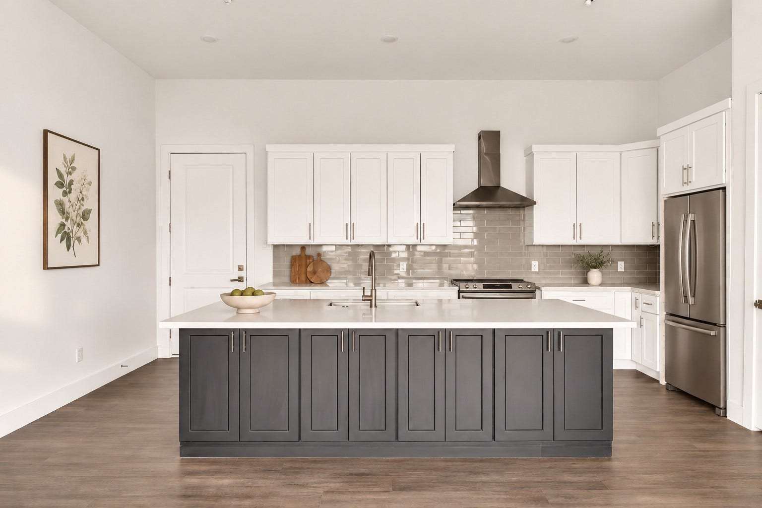 119 Kirby Road, #5303, Taylor Lake Village, TX 77586 Sleek modern kitchen with a large island, stainless steel appliances, and elegant white cabinetry complemented by a chic gray backsplash.