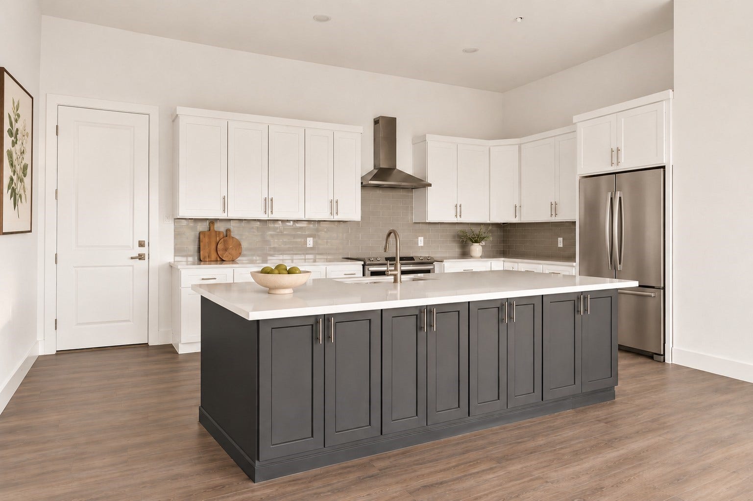 119 Kirby Road, #5303, Taylor Lake Village, TX 77586 Elegant kitchen featuring a spacious island with contrasting cabinetry, modern stainless steel appliances, and sleek white countertops, perfect for culinary enthusiasts.