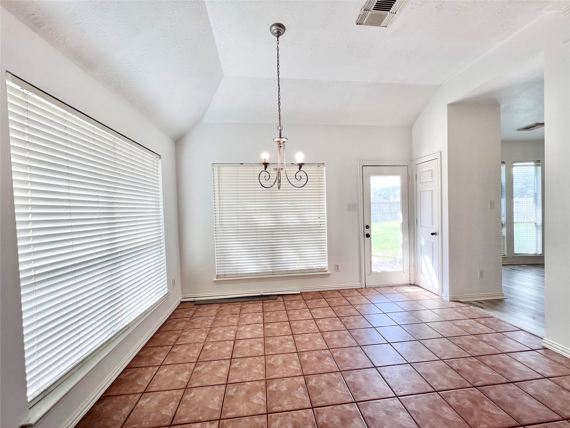 Breakfast room with ceramic tile floors, with an access door to  patio area