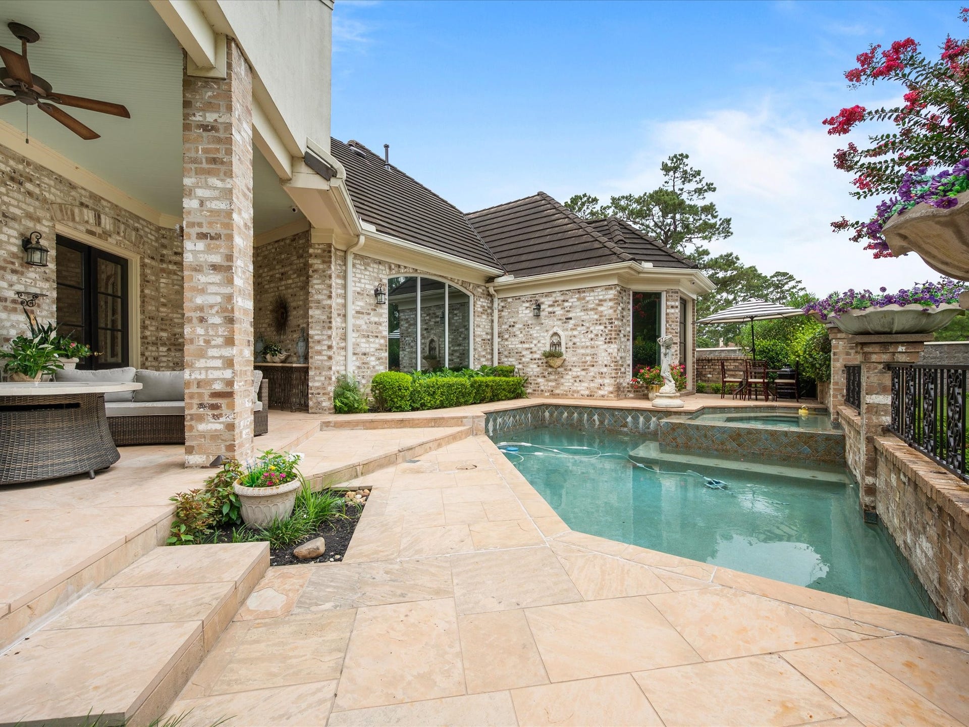 Thoughtfully designed for year-round enjoyment, the pool, patio, and covered outdoor living spaces invite both lively gatherings and peaceful evenings at home.