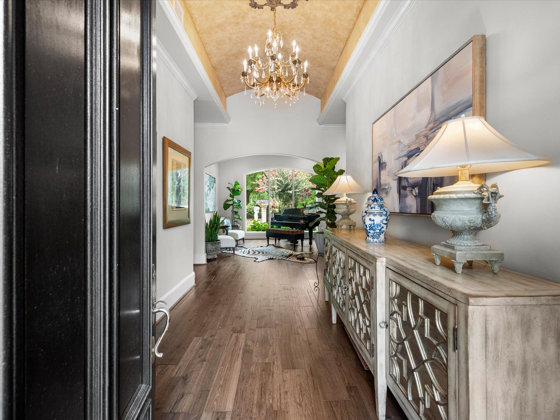 A grand foyer welcomes guests with soaring ceilings and an elegant barrel ceiling, setting the tone for the refined interiors that await.