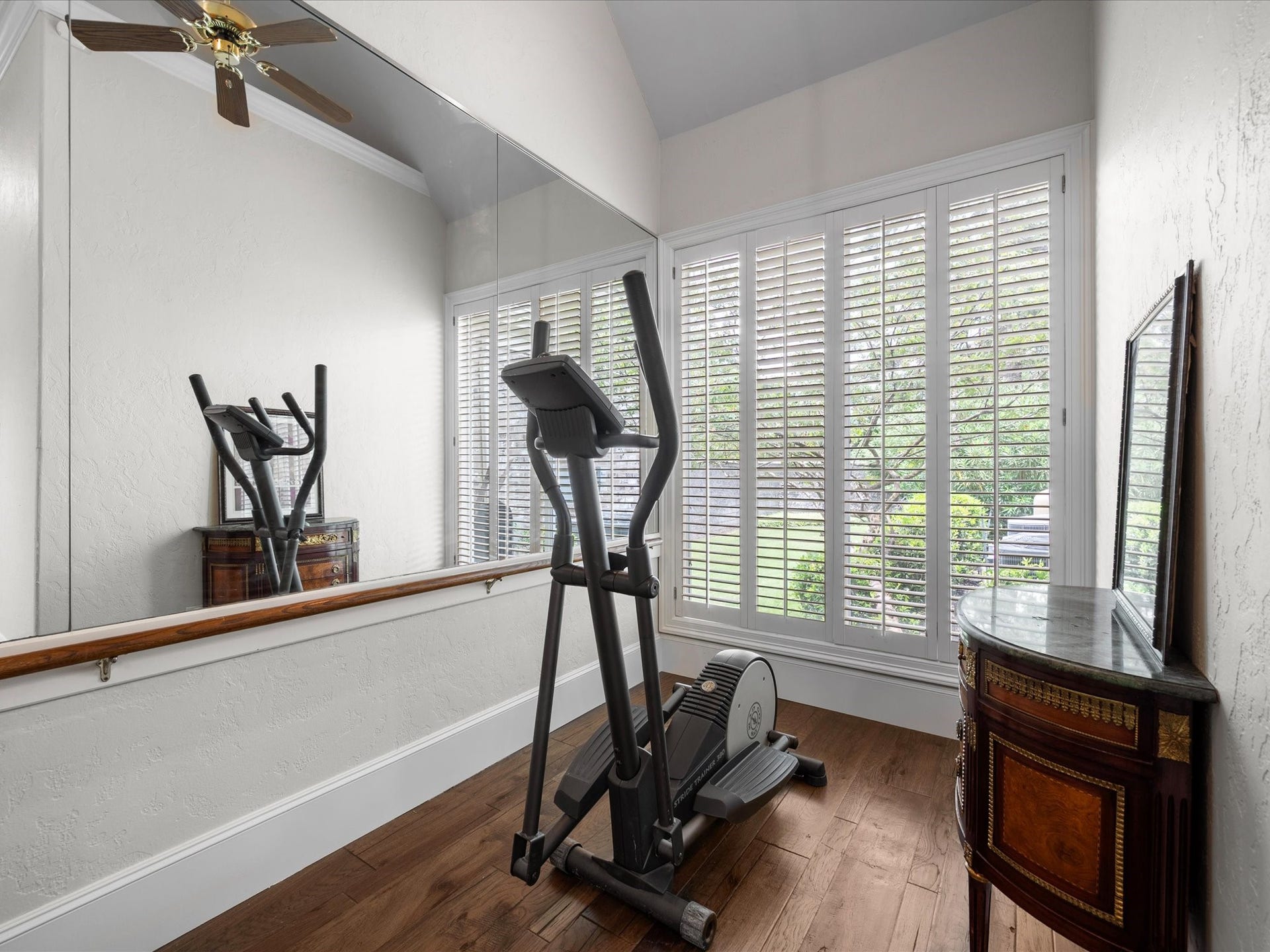Imagine beginning each day with a quiet workout, morning stretch, or moment of reflection in this light-filled retreat thoughtfully tucked away within the primary suite.