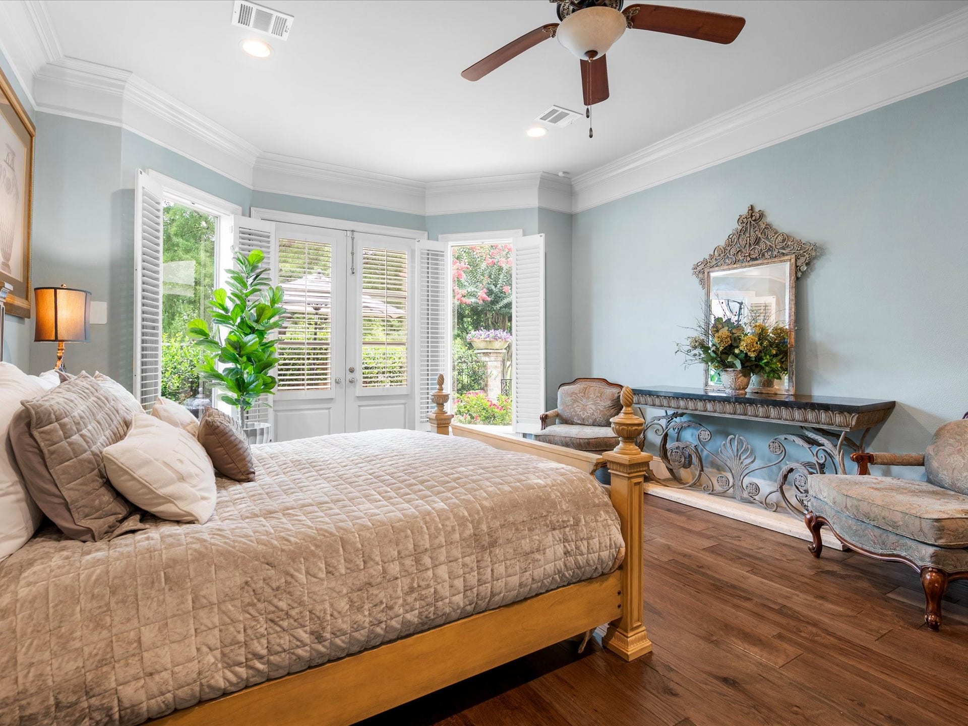 Wake each morning to soft natural light and tranquil garden views in this serene primary retreat, where generous proportions and peaceful surroundings invite relaxation at the start and end of each day.