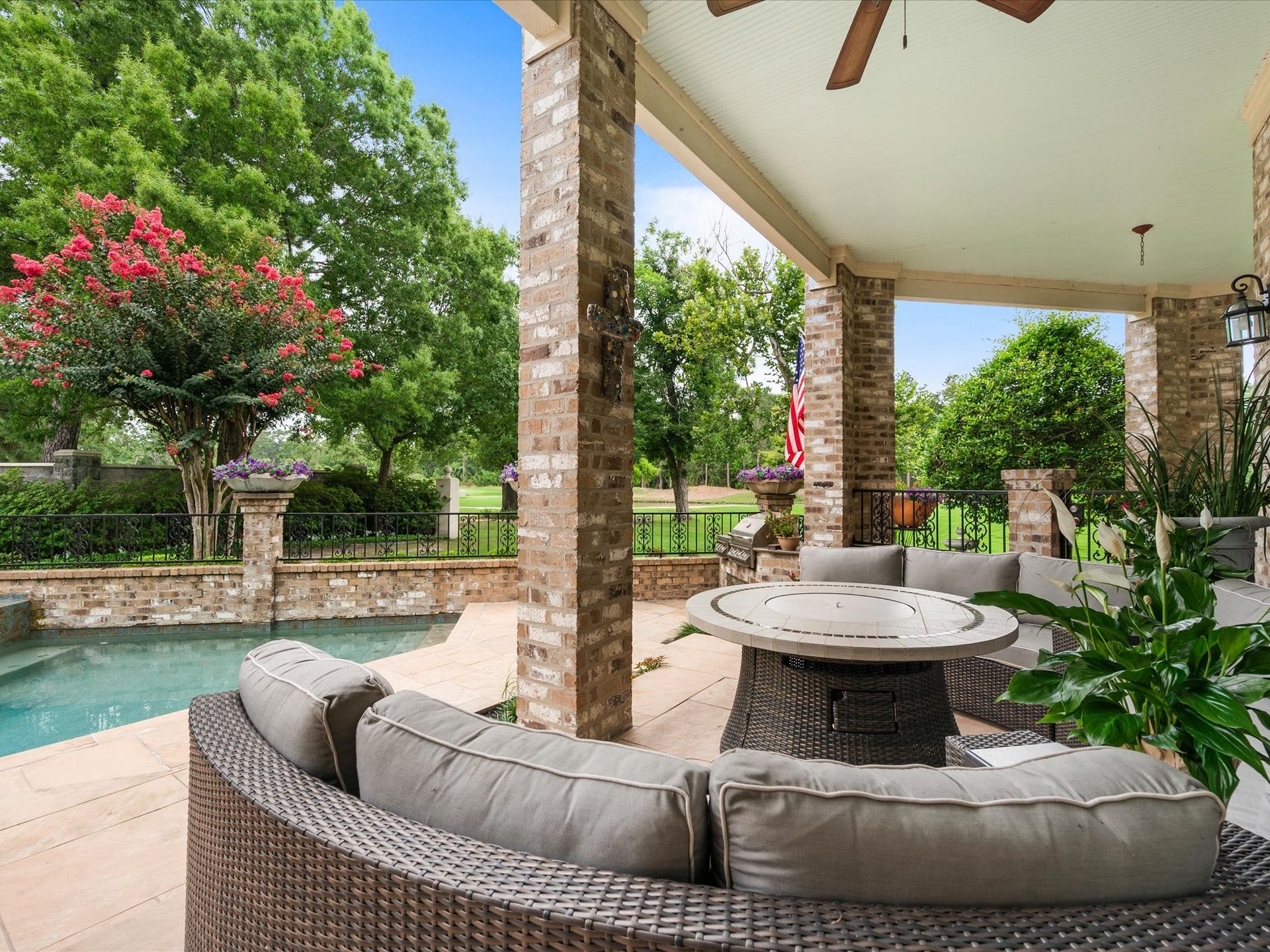 Expansive sandstone patio spaces overlook the pool and fairways beyond, offering a seamless blend of outdoor entertaining and tranquil golf course living.
