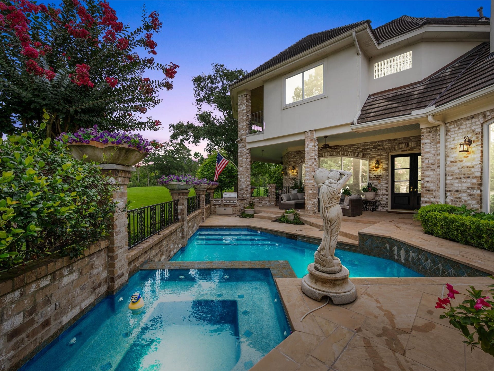 Resort-inspired outdoor living awaits with an expansive patio overlooking the sparkling pool and spa, creating the perfect setting for both lively gatherings and peaceful evenings at home.