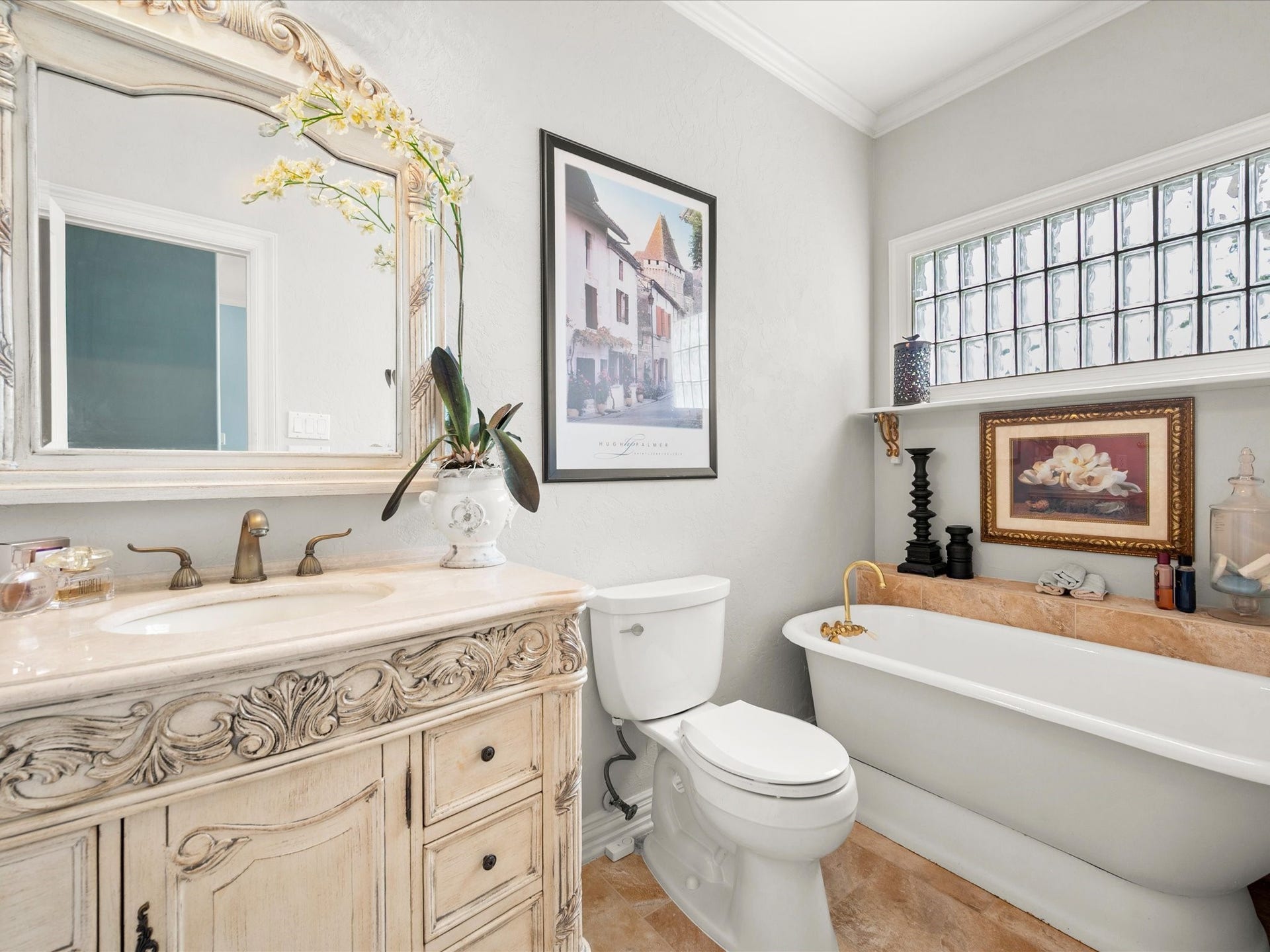 Thoughtfully designed with elegant details, this beautifully appointed bath features a relaxing soaking tub, detailed vanity, and framed mirror, creating a refined space for family and guests.