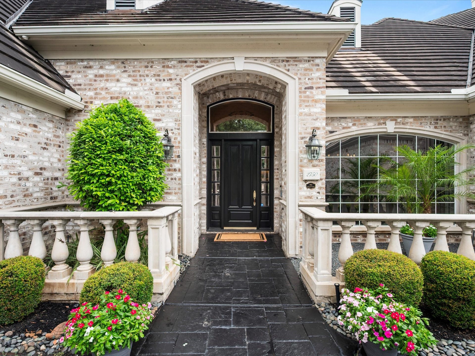 Meticulously maintained grounds and lush landscaping complement the home's stately brick faade, reflecting the exceptional care invested throughout the property.
