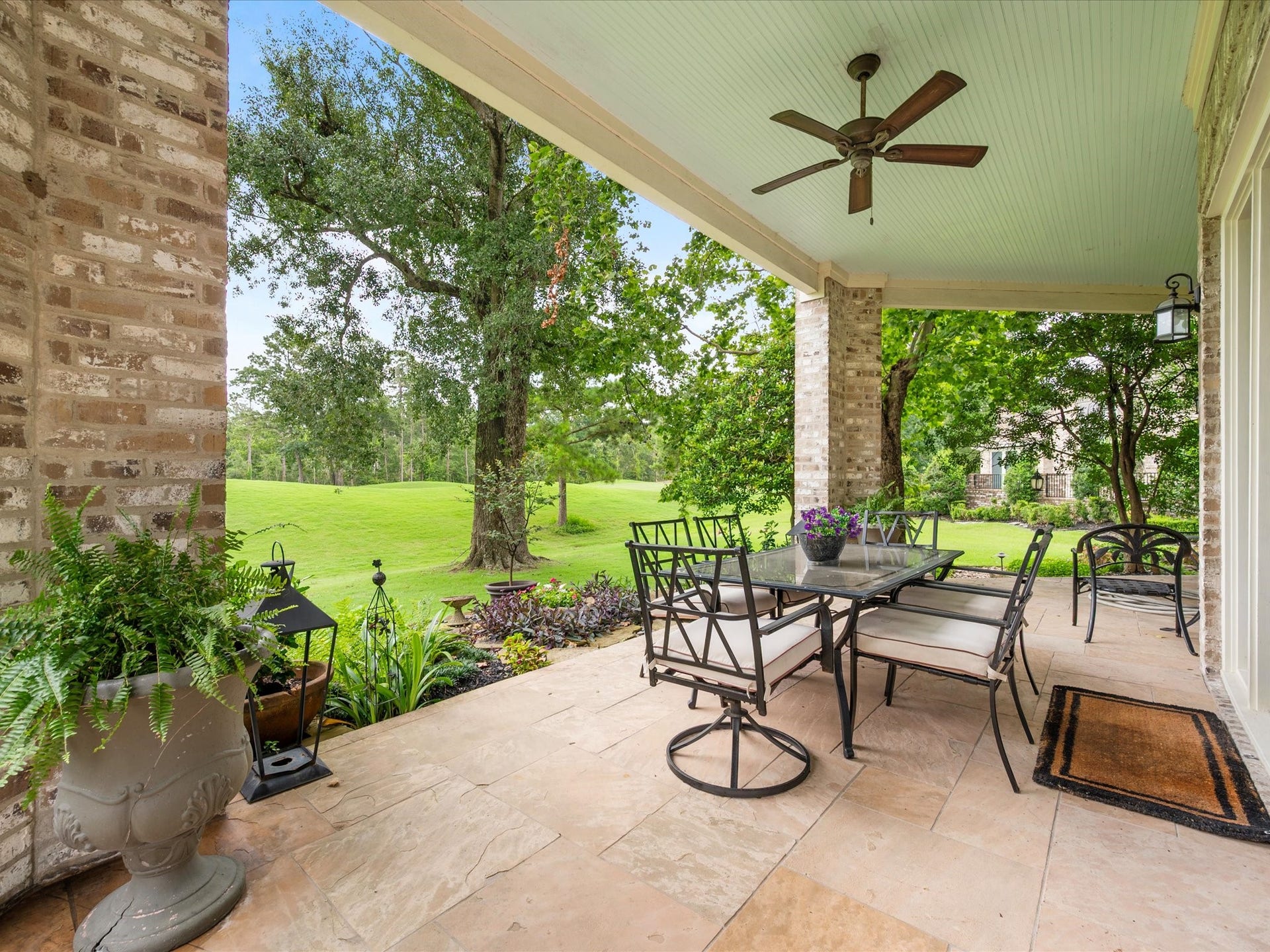 The covered patio provides a peaceful escape to enjoy morning coffee, evening conversations, and uninterrupted views of the fairways beyond.