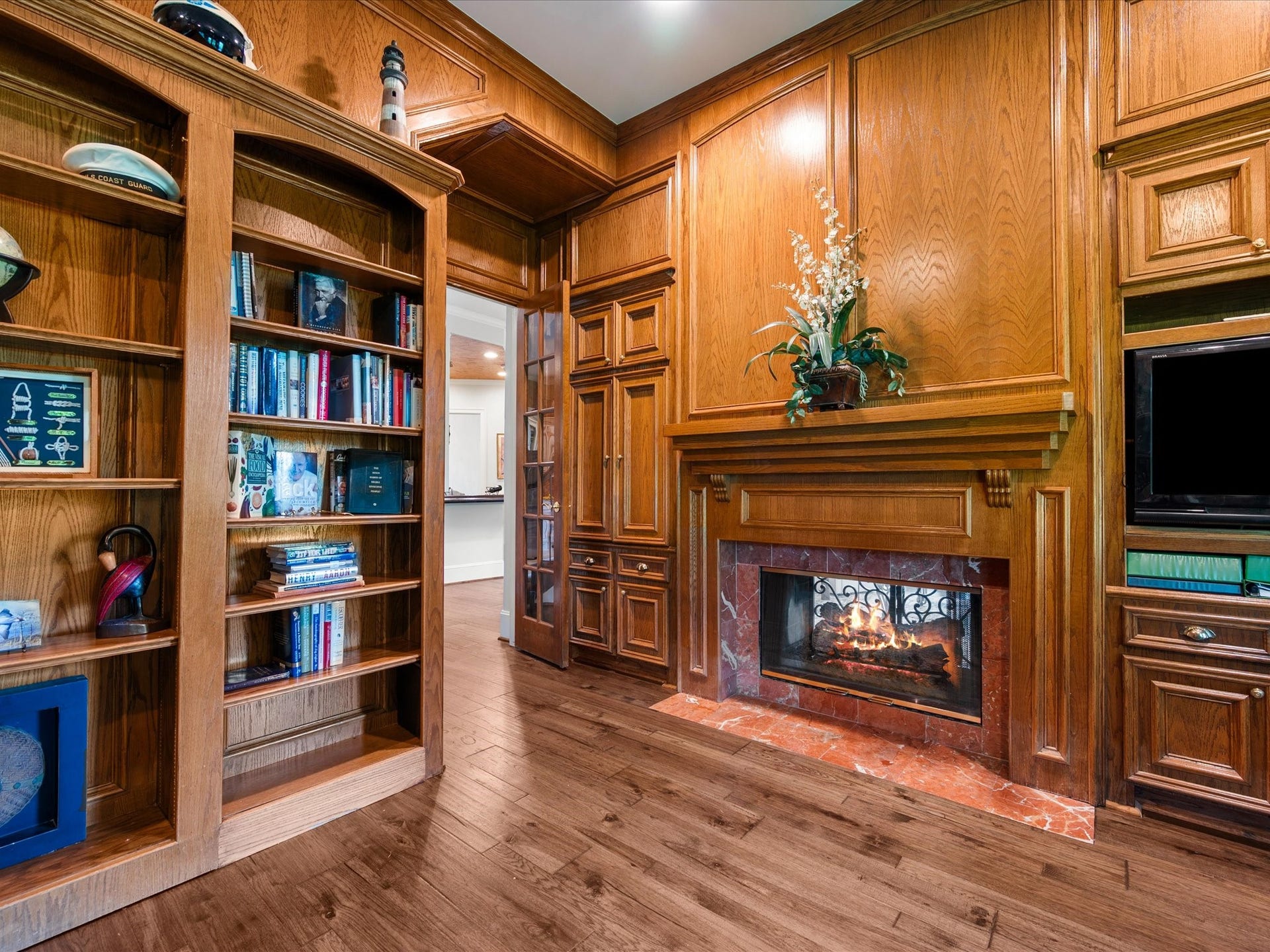 A beautiful fireplace and peaceful golf course setting transform the study into a warm, inviting retreatequally suited for quiet reflection, reading, or productive workdays.