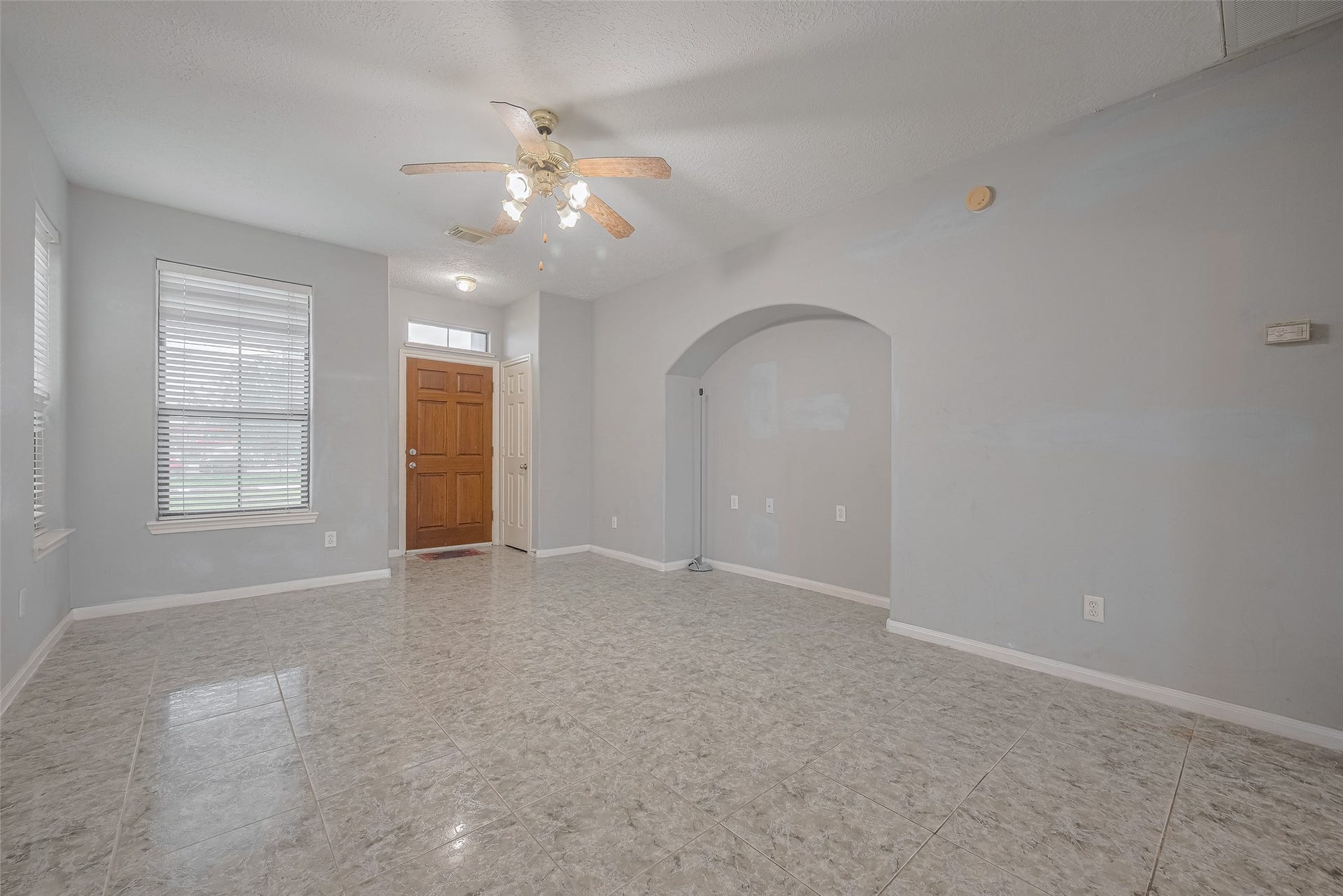 11214 Palmsprings Drive, Houston, TX 77034 Alternate living-room view shows the front entry, window blinds, and decorative wall niche.