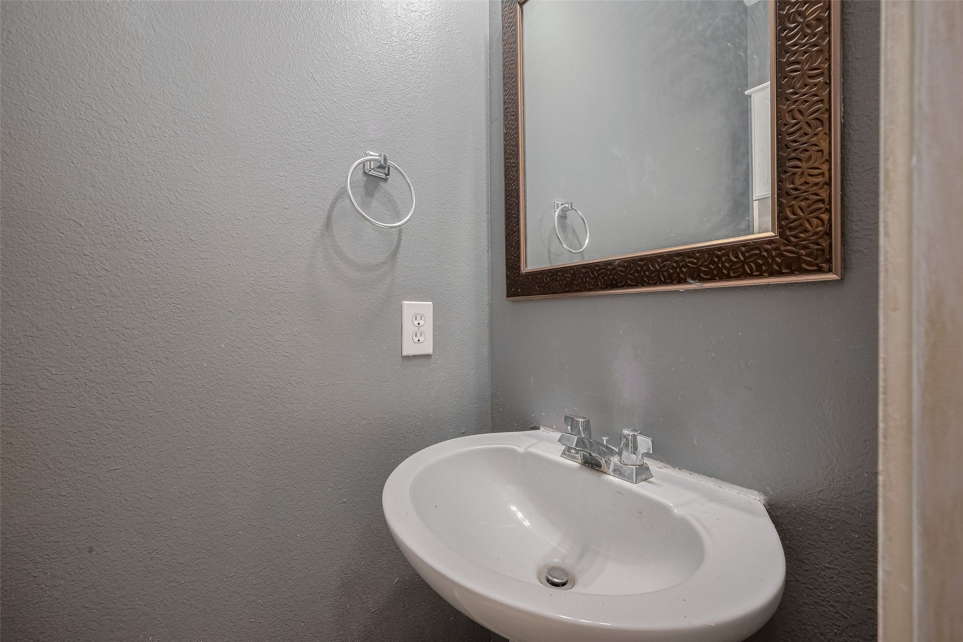 11214 Palmsprings Drive, Houston, TX 77034 Downstairs half bath includes a pedestal sink and framed mirror.