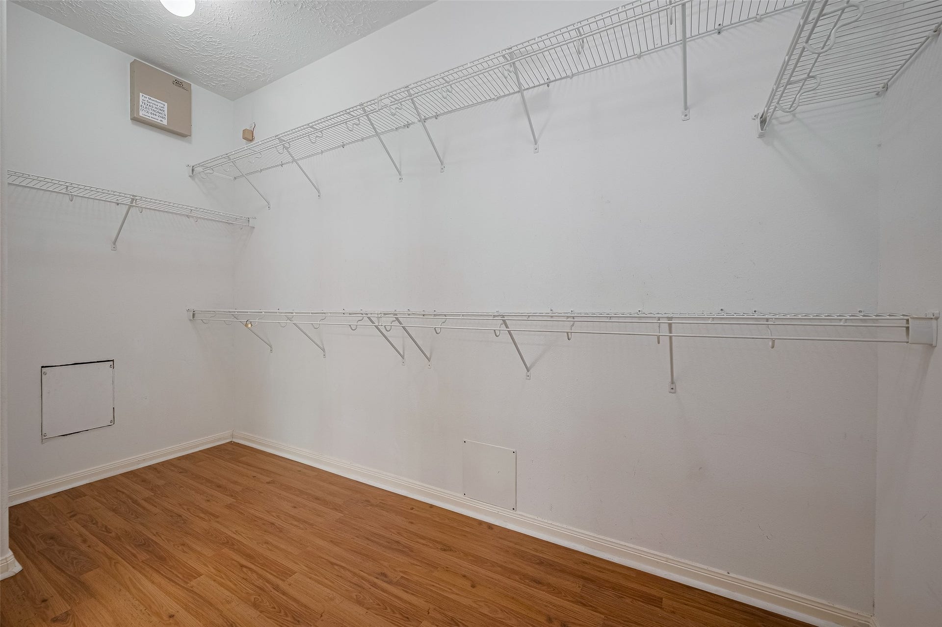 11214 Palmsprings Drive, Houston, TX 77034 Primary walk-in closet offers hanging space and shelving along multiple walls.
