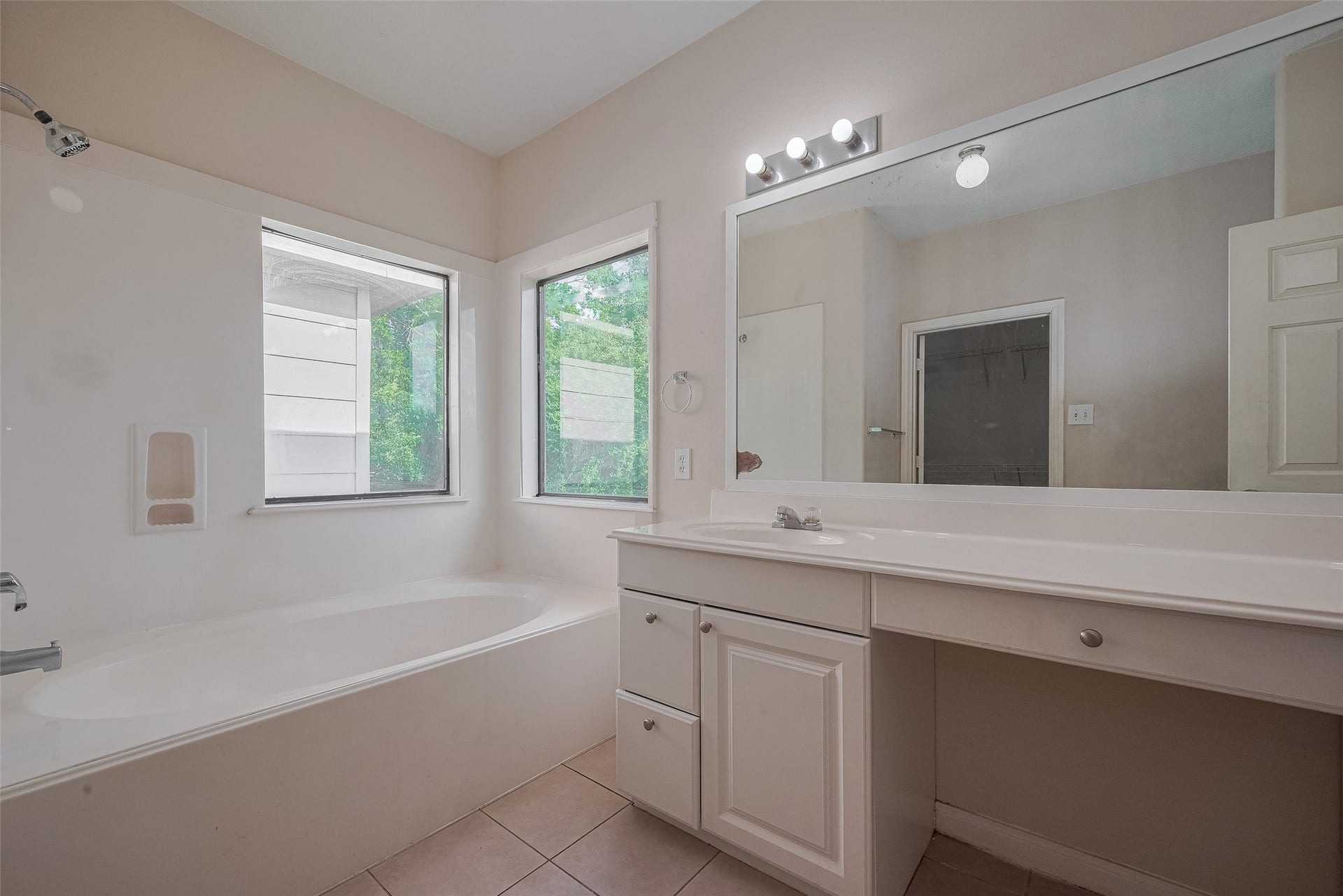 11214 Palmsprings Drive, Houston, TX 77034 Another primary-bathroom view highlights the soaking tub, surrounding windows, and vanity storage.
